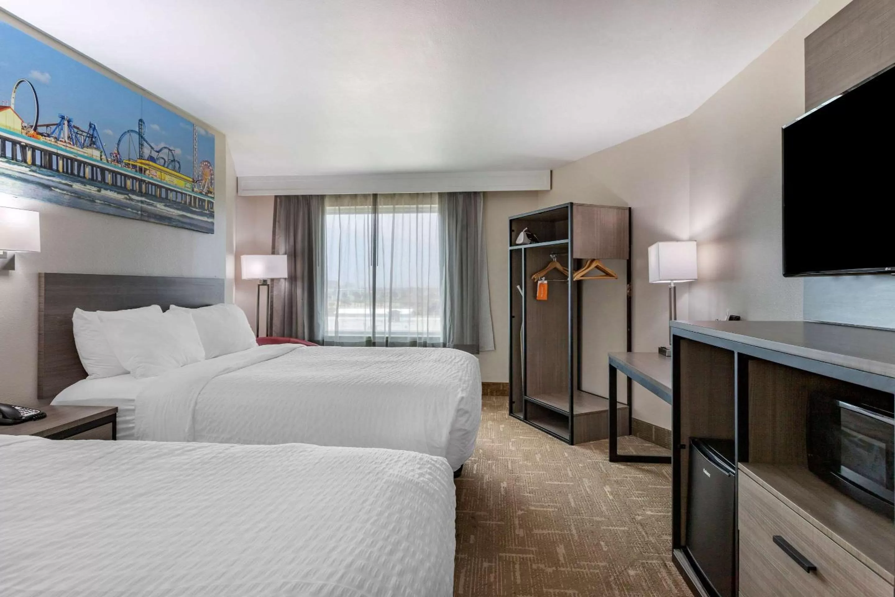Bed, TV/Entertainment Center in Clarion Pointe Galveston Seawall
