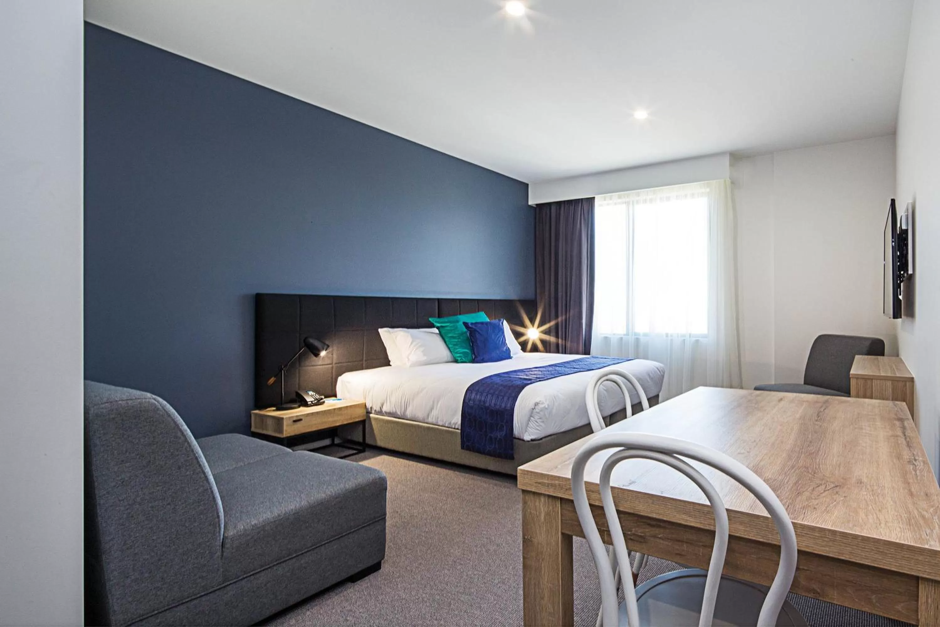 Seating area, Bed in Mantra MacArthur Hotel