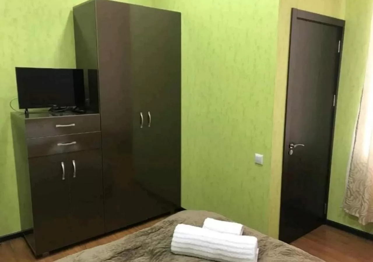 Bed, TV/Entertainment Center in Gamarjoba Hotel