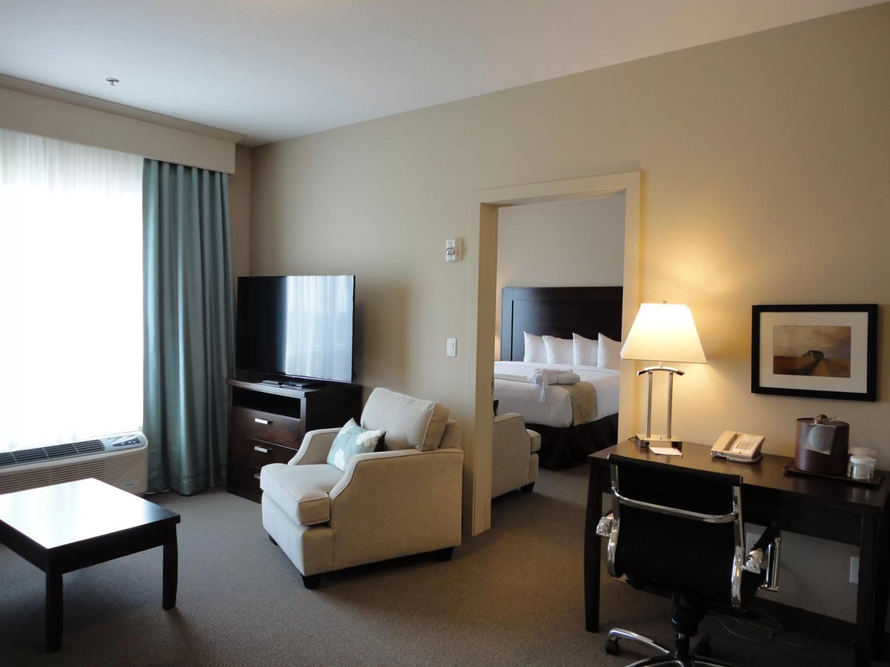 Living room, Bed in Ramada by Wyndham Emerald Park/Regina East
