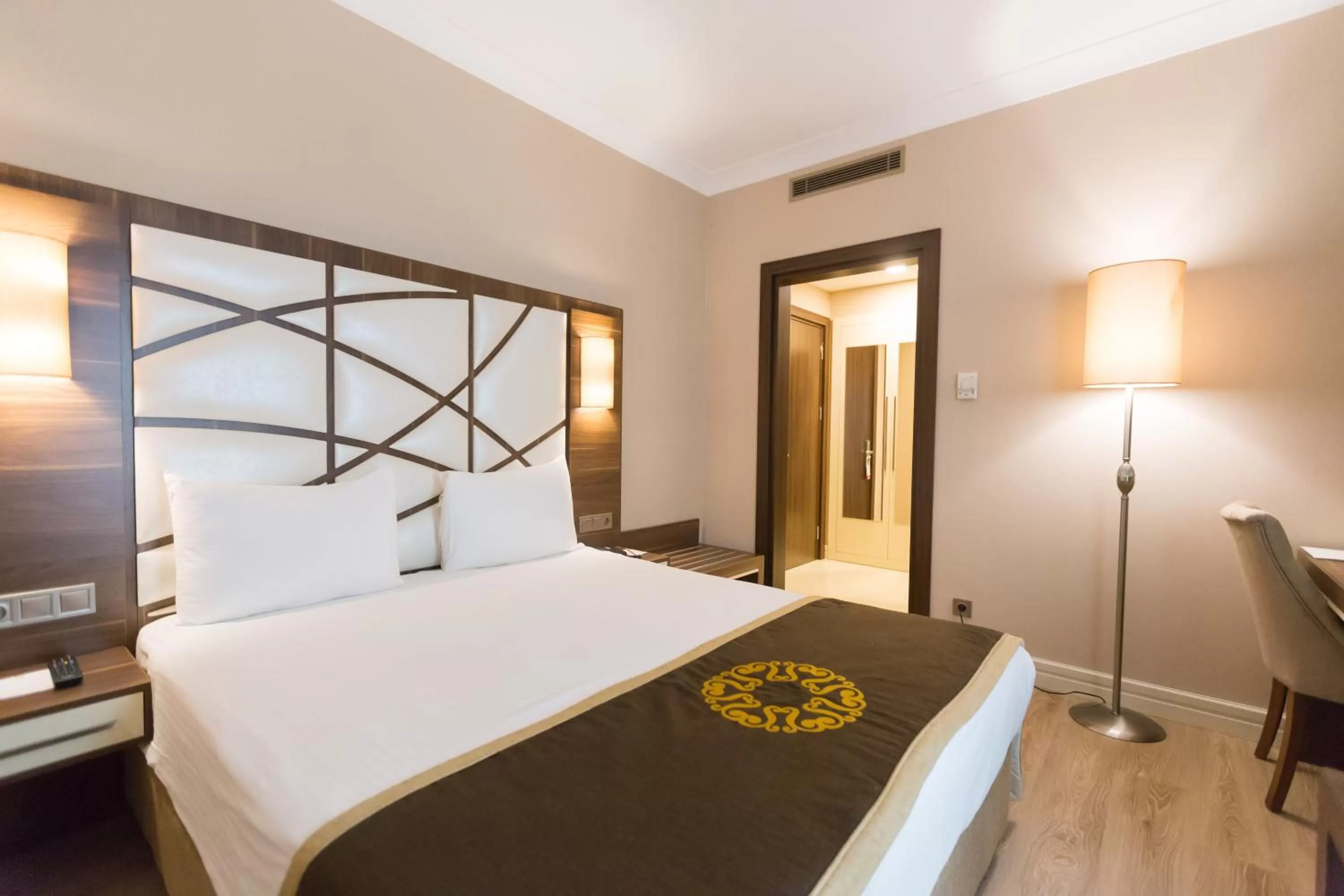 Bed in The Grand Mira Business Hotel