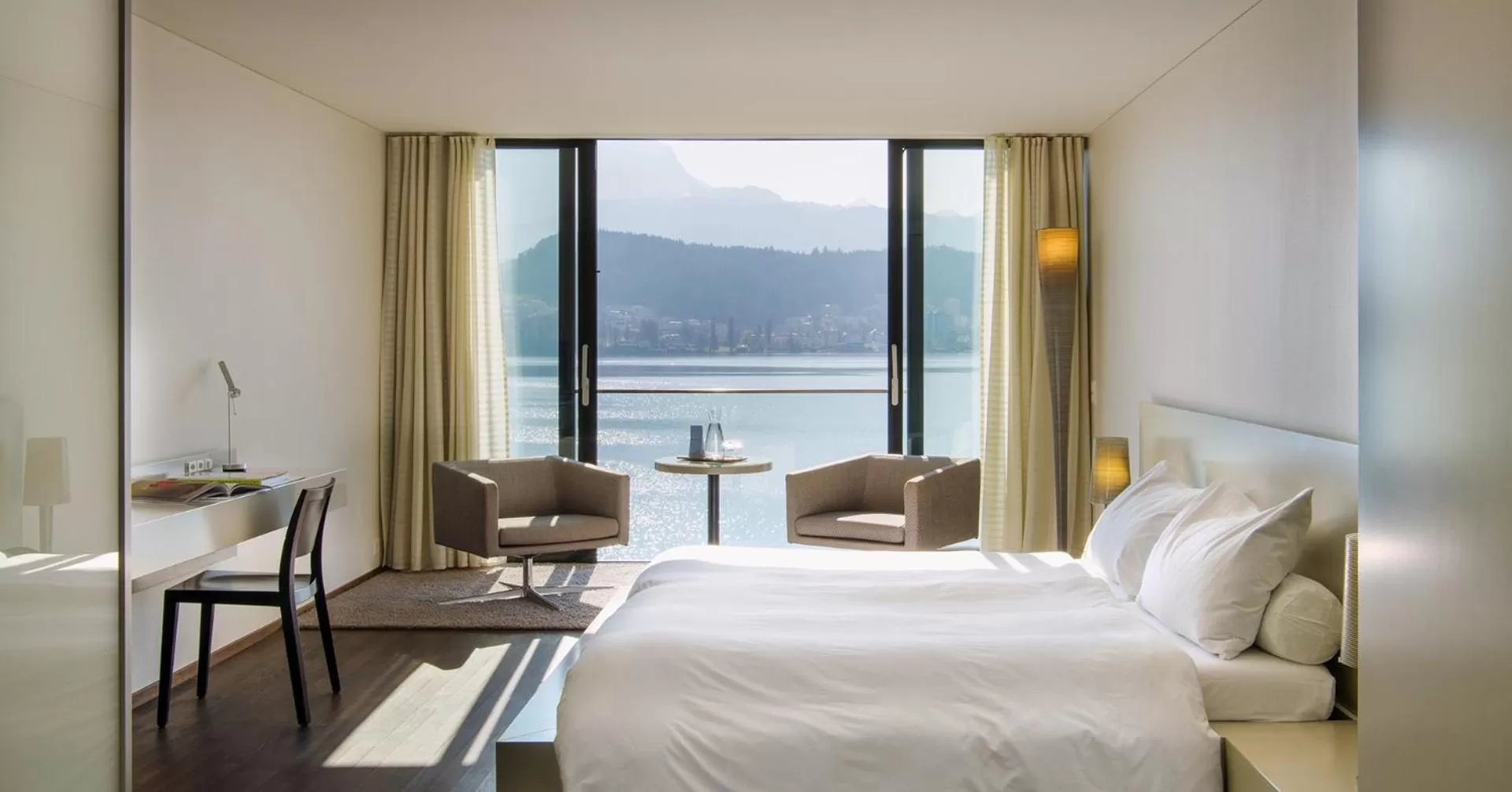 Photo of the whole room, Bed in HERMITAGE Lake Lucerne - Beach Club & Lifestyle Hotel