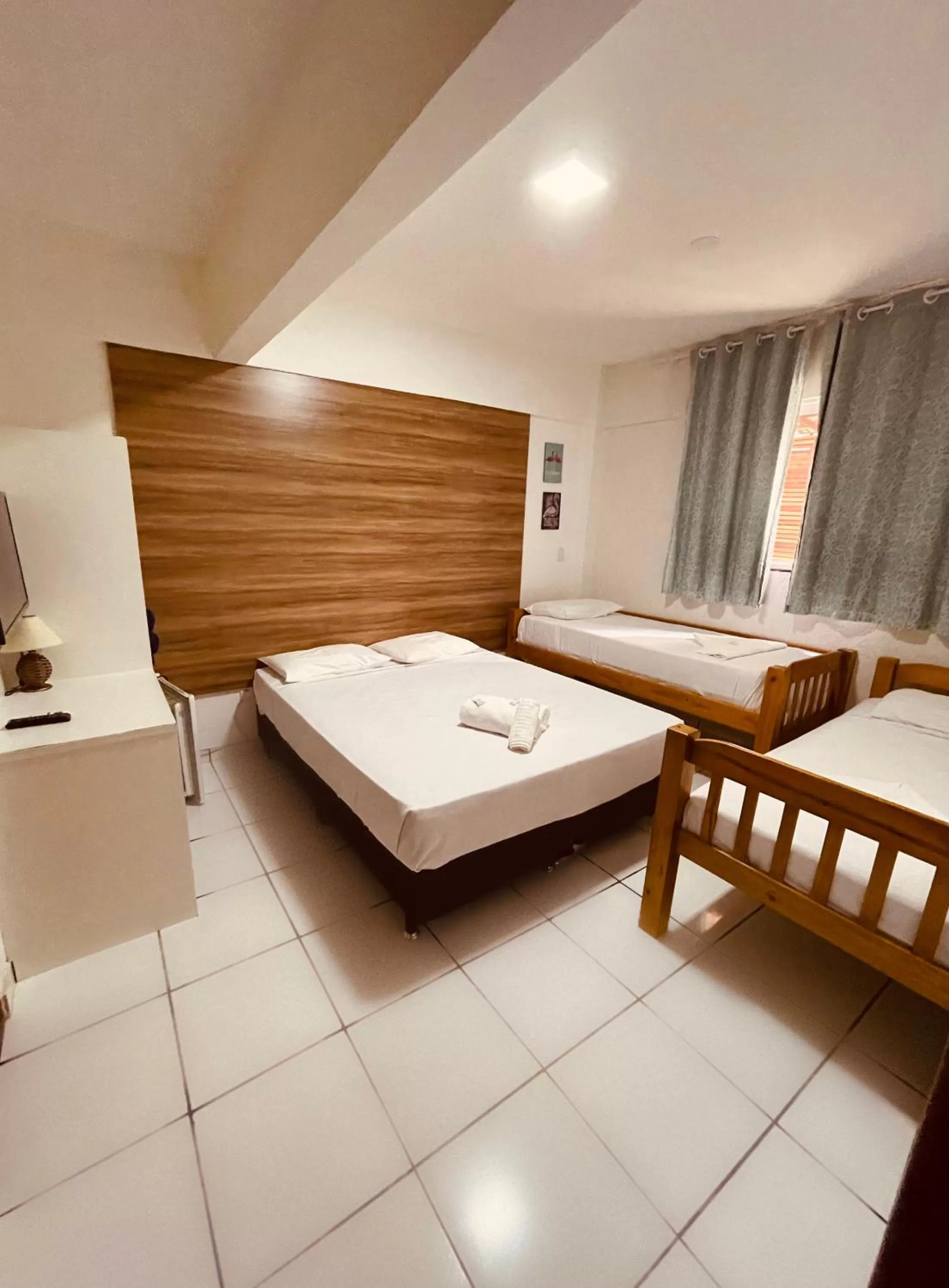 Bed in Flamingo Beach Pousada