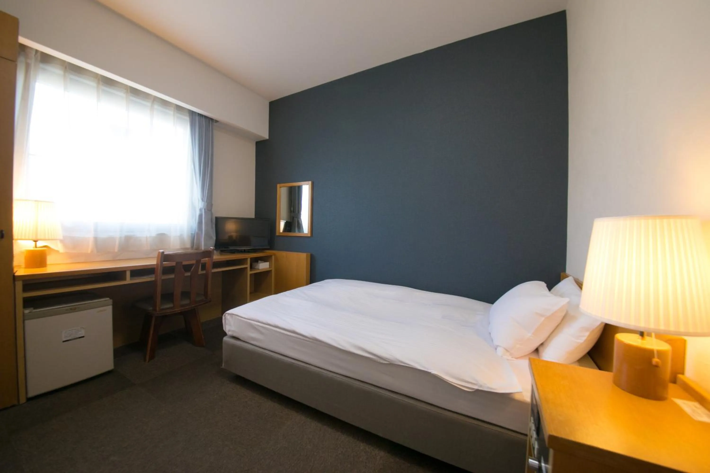 Bed in Heiwadai Hotel 5