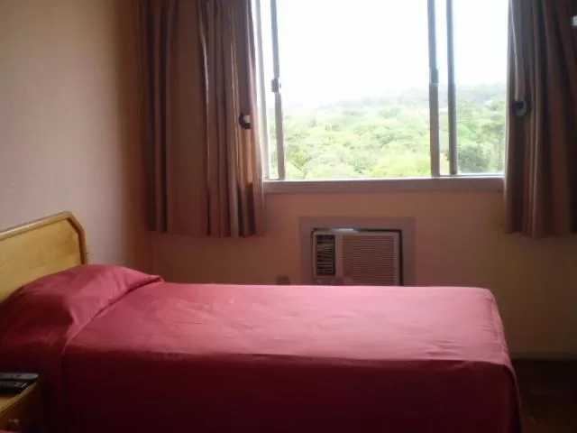 Bed in Hotel Gravataí Center