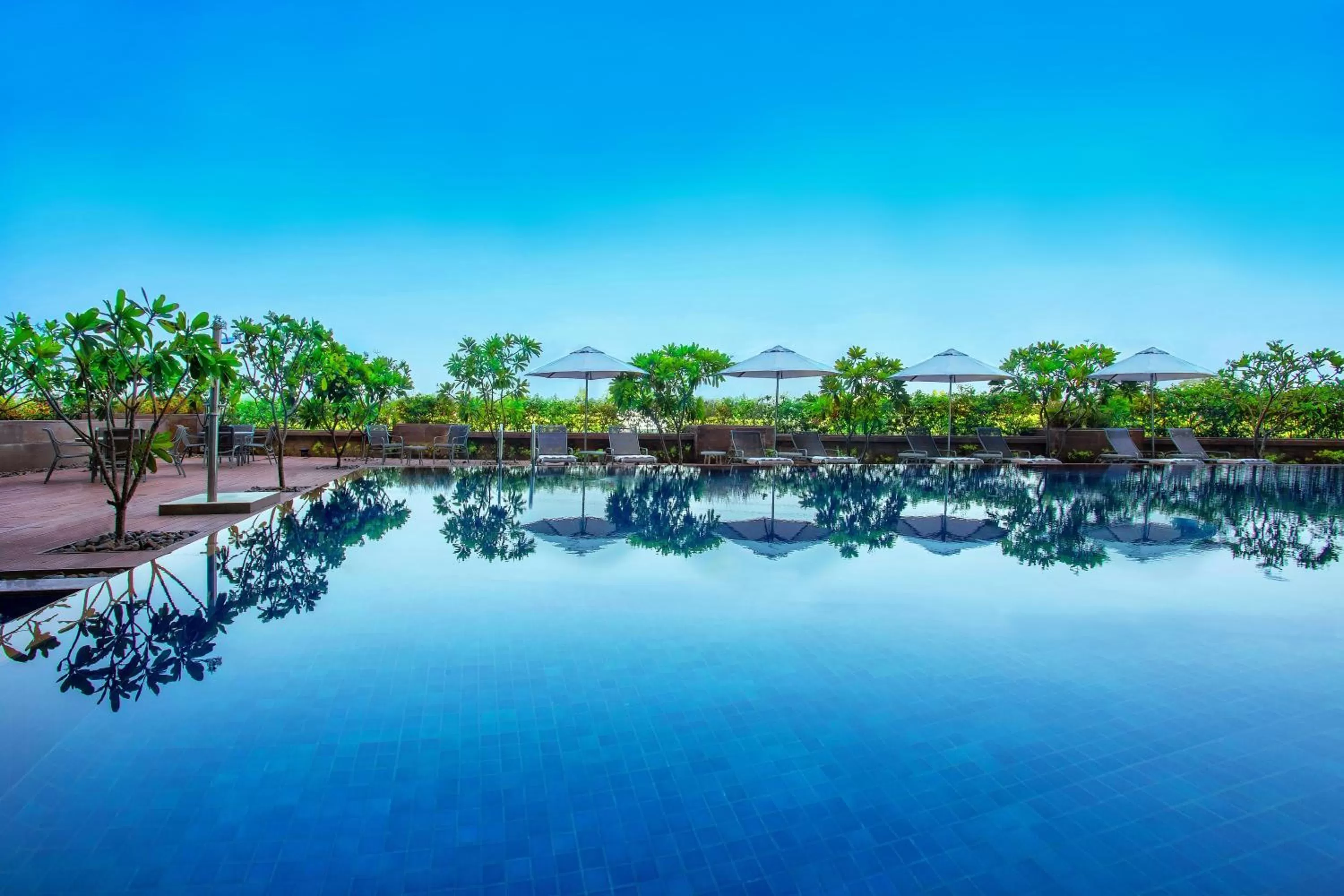 Swimming pool in Crowne Plaza Ahmedabad City Centre by IHG