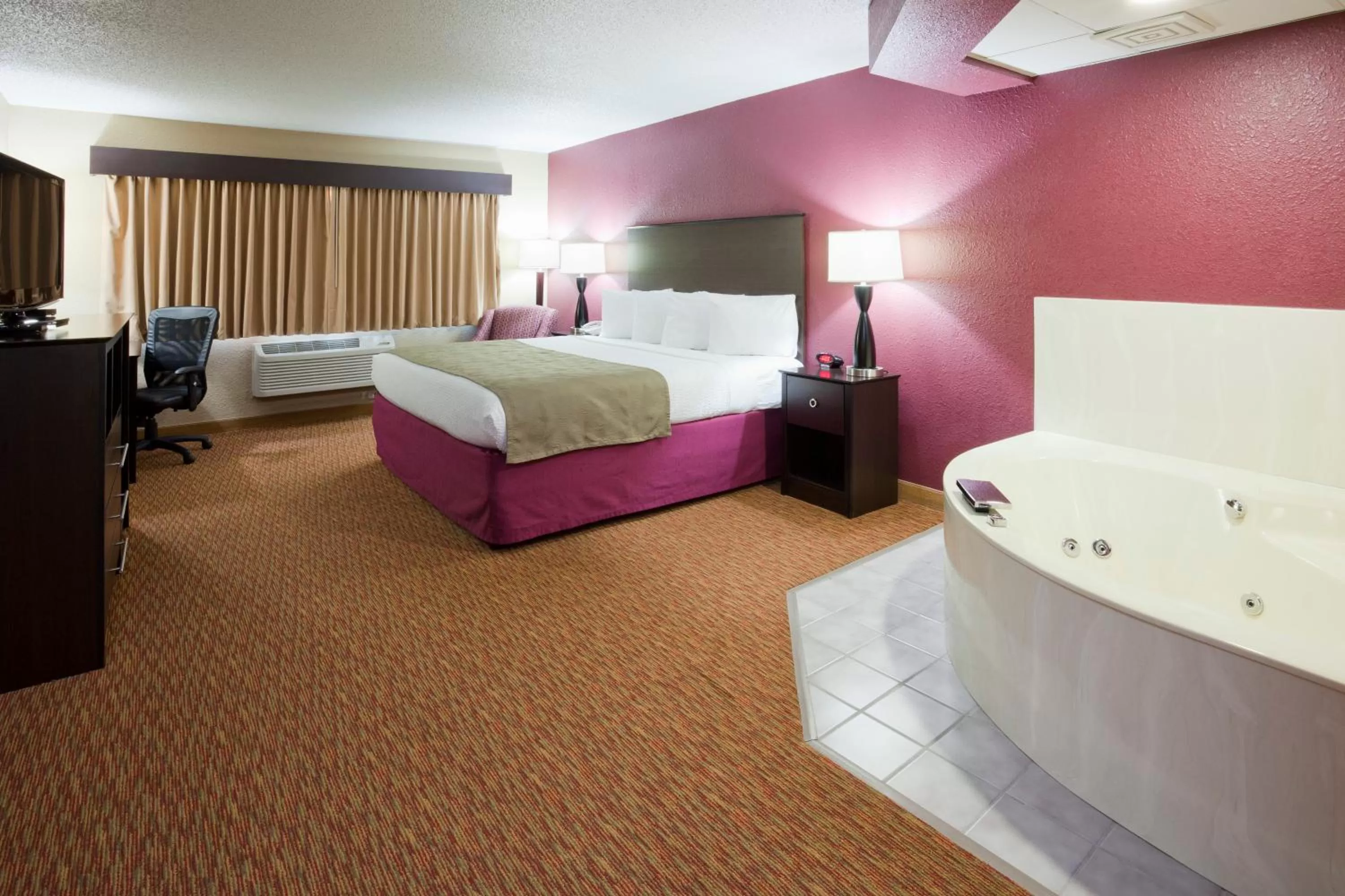 Bed in AmericInn by Wyndham Osceola