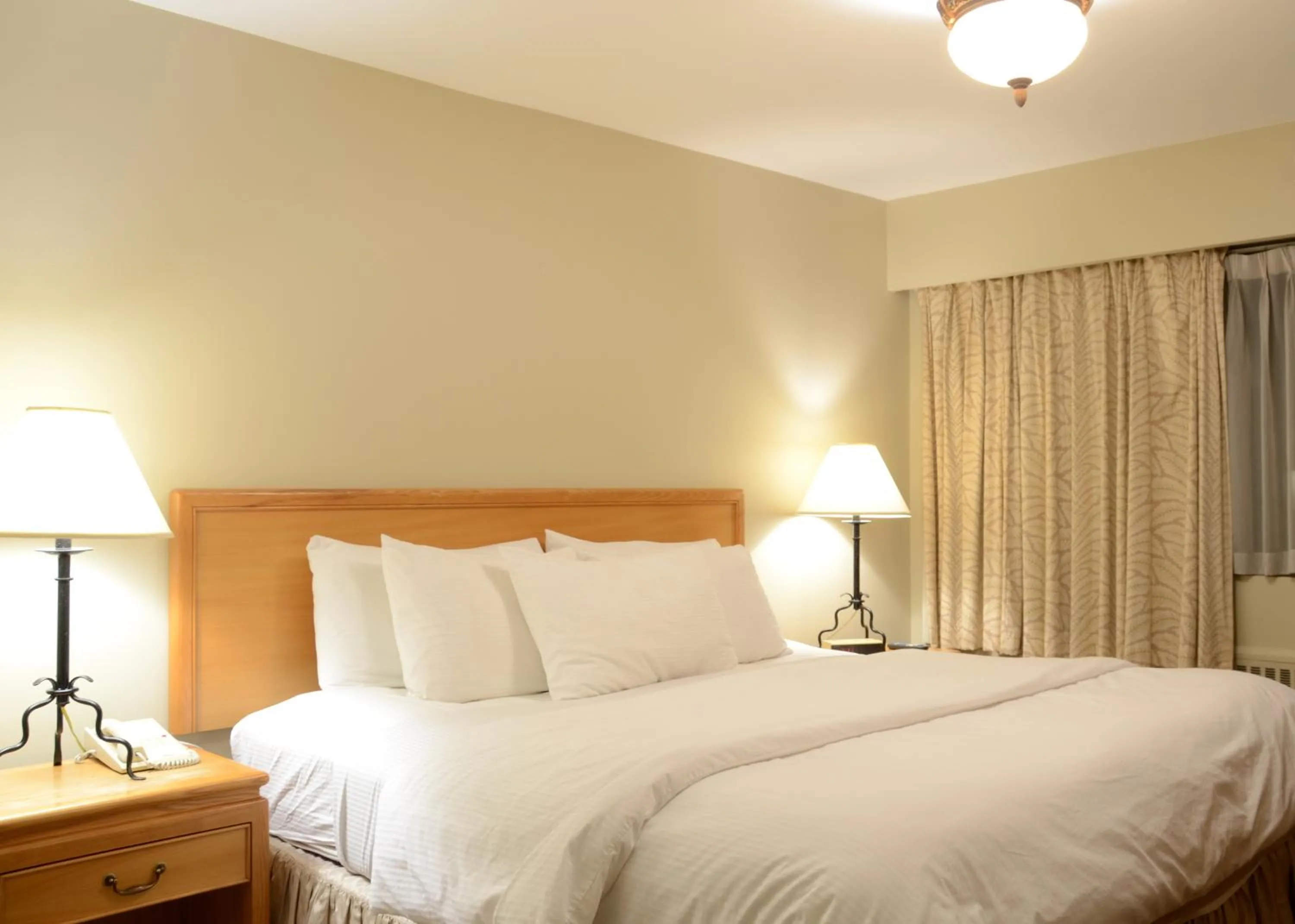 Bed in Rosellen Suites at Stanley Park