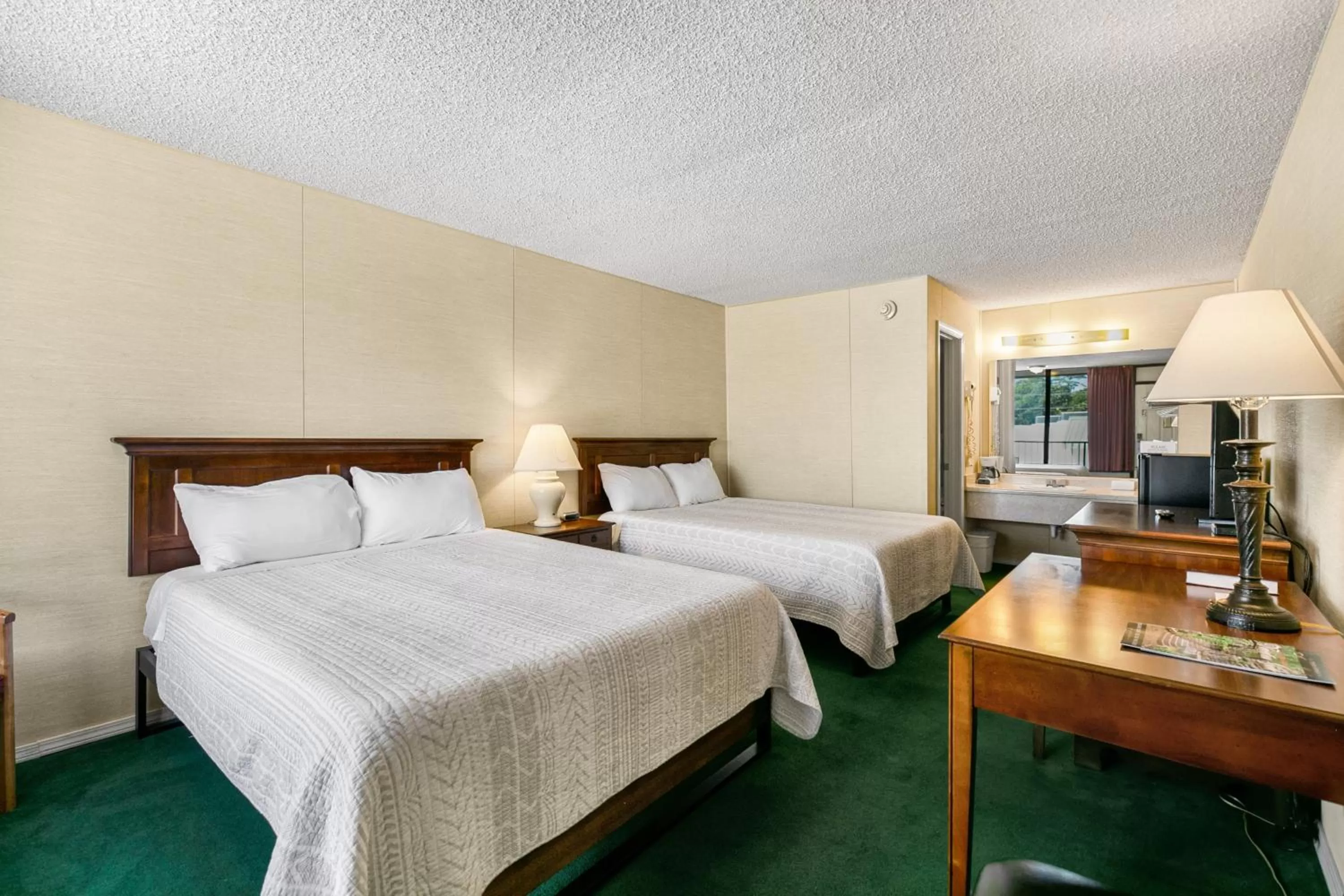 Bed in Candlewick Inn and Suites