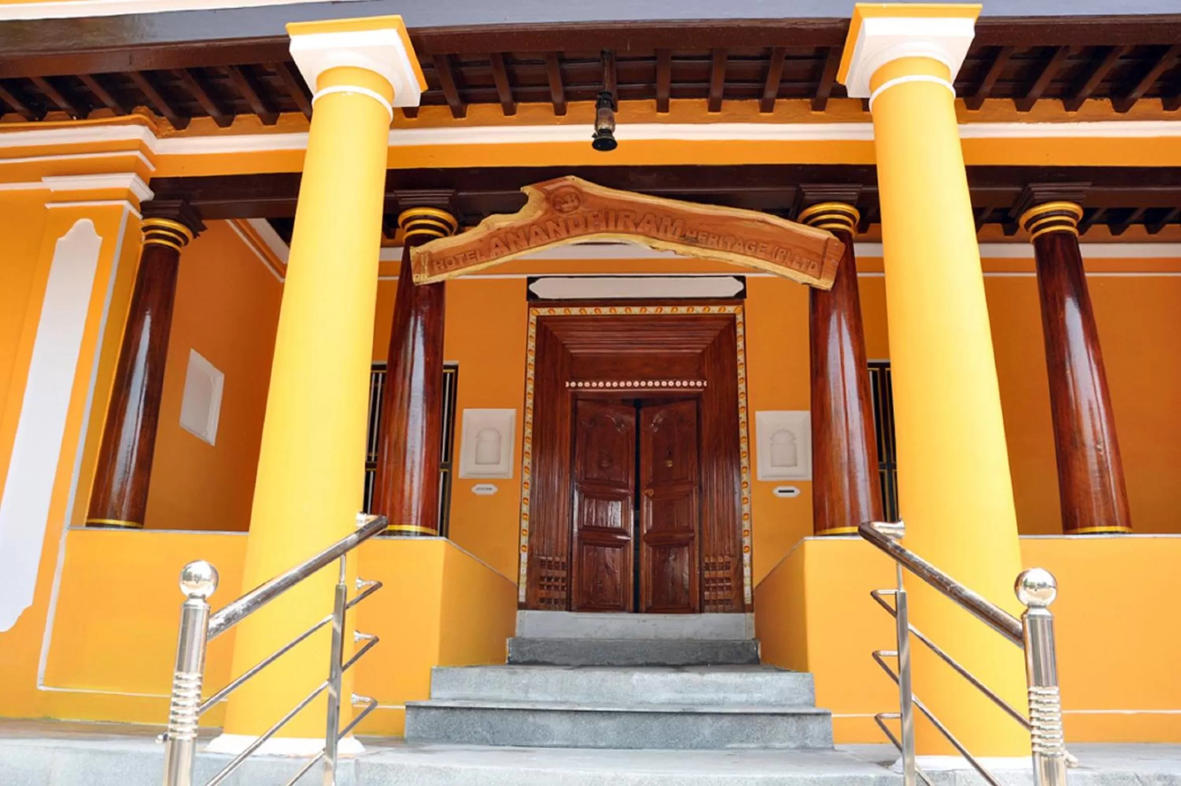 Property logo or sign in Hotel Anandhiram Heritage