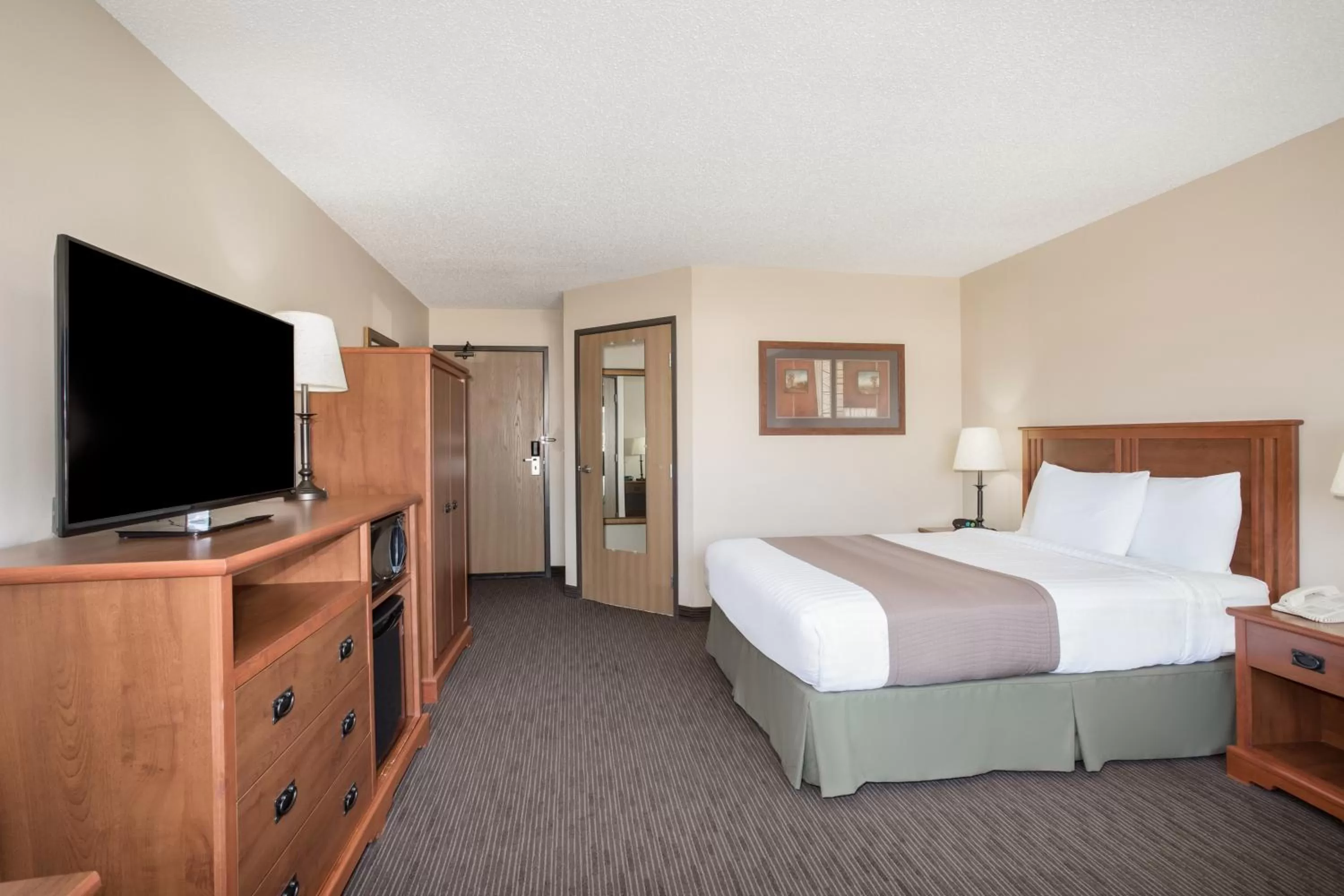 Bed in AmericInn by Wyndham Sioux City
