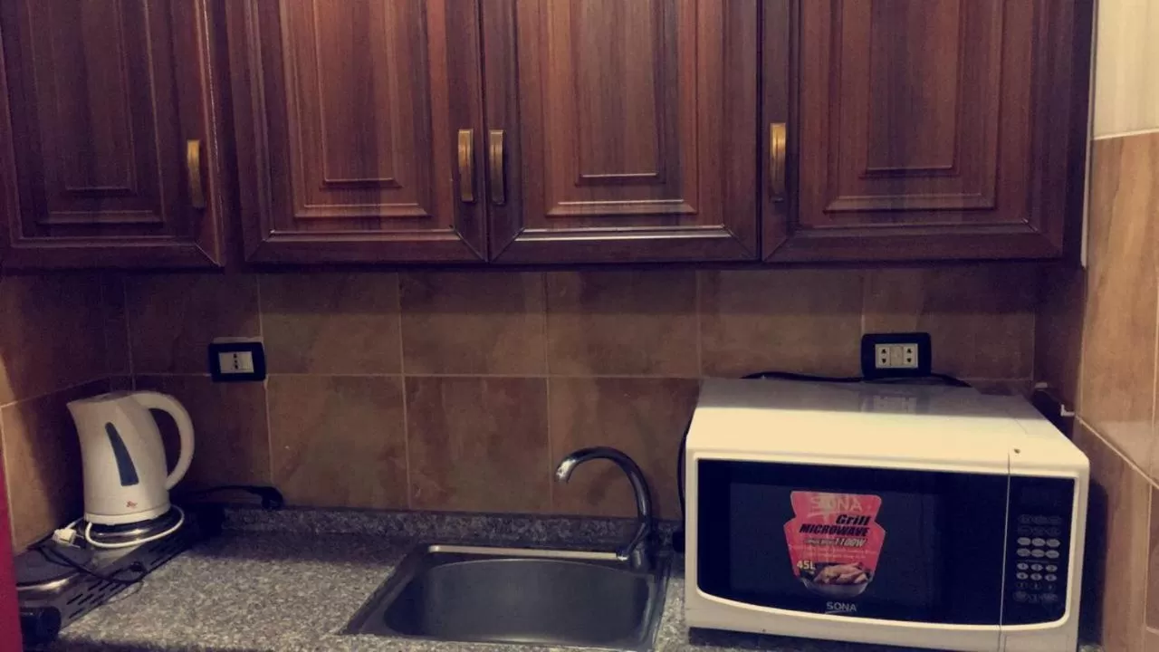 Kitchen or kitchenette in Al Tawheed Hotel Apartments