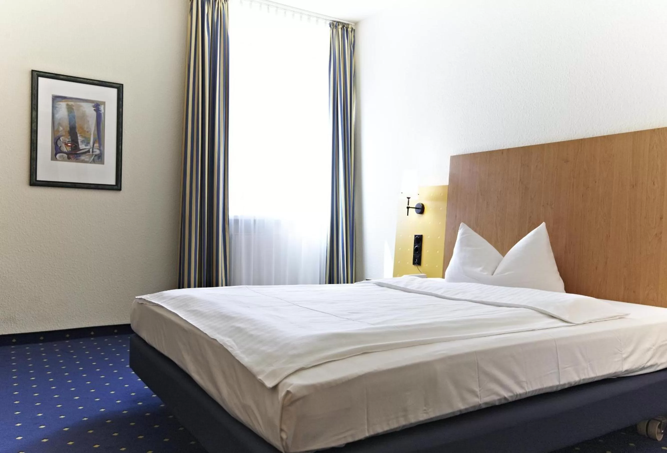 Bed in IntercityHotel Stralsund