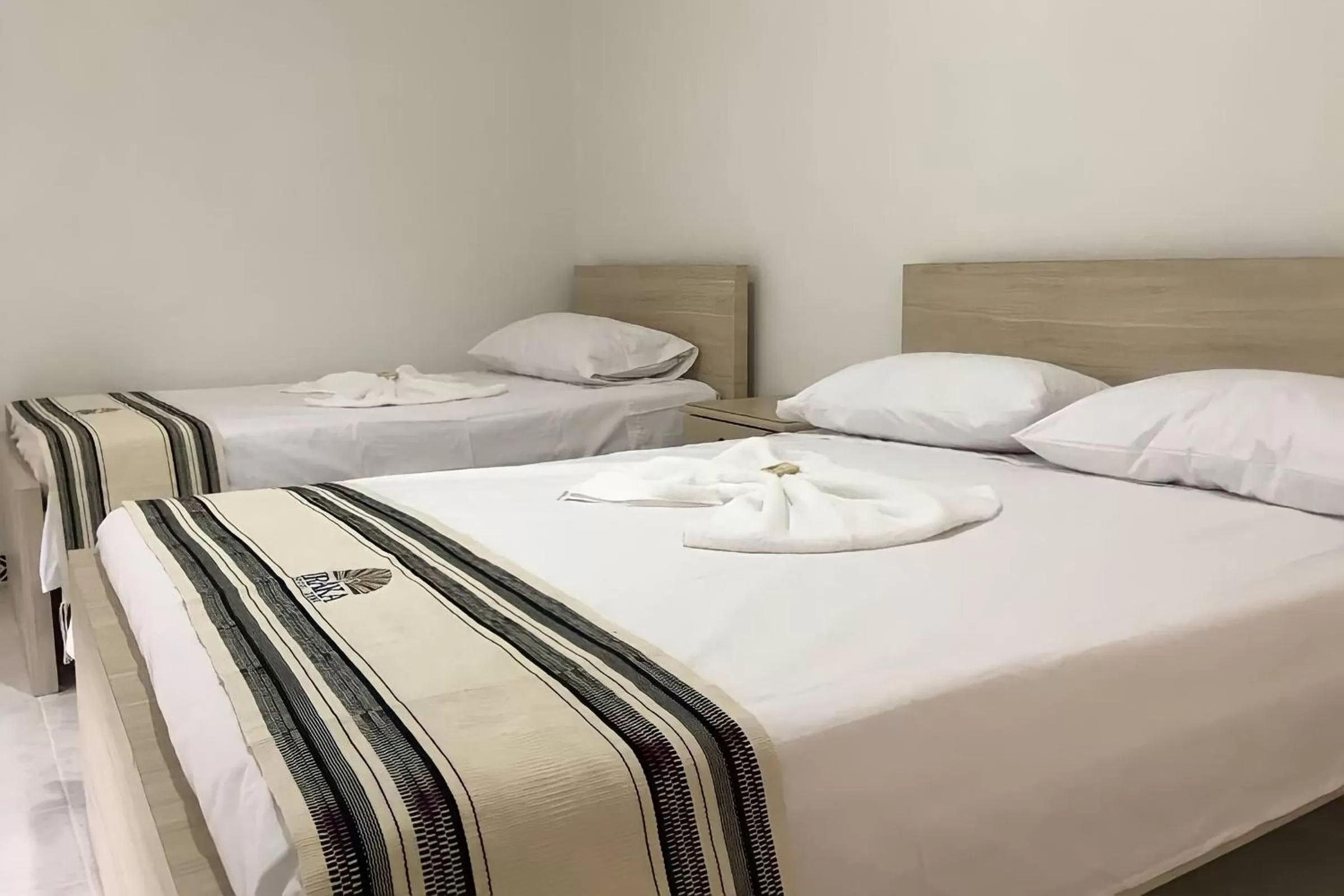 Bed in Hotel Iraka Zenu