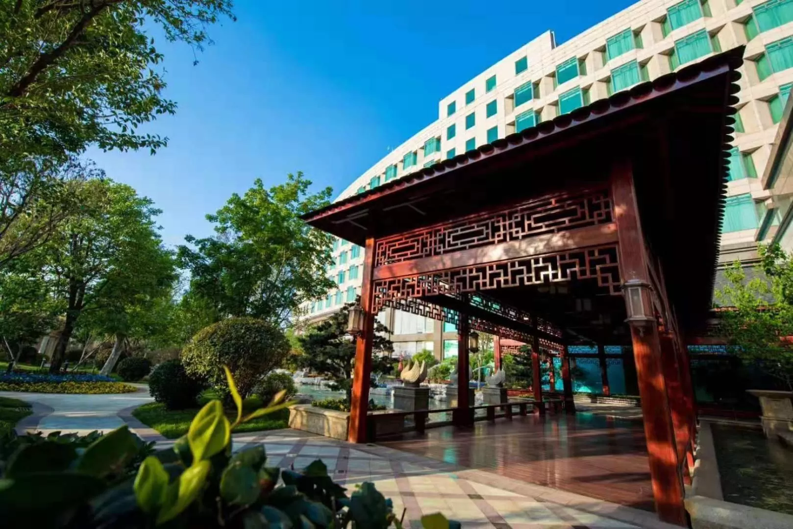 Property building in Wyndham Qingdao l Free Fixed-Time Shuttle Service Between Hotel and Airport & North Railway Station l Outdoor Children's Amusement Park l 1-Hour Play Snooker or Table Tennis