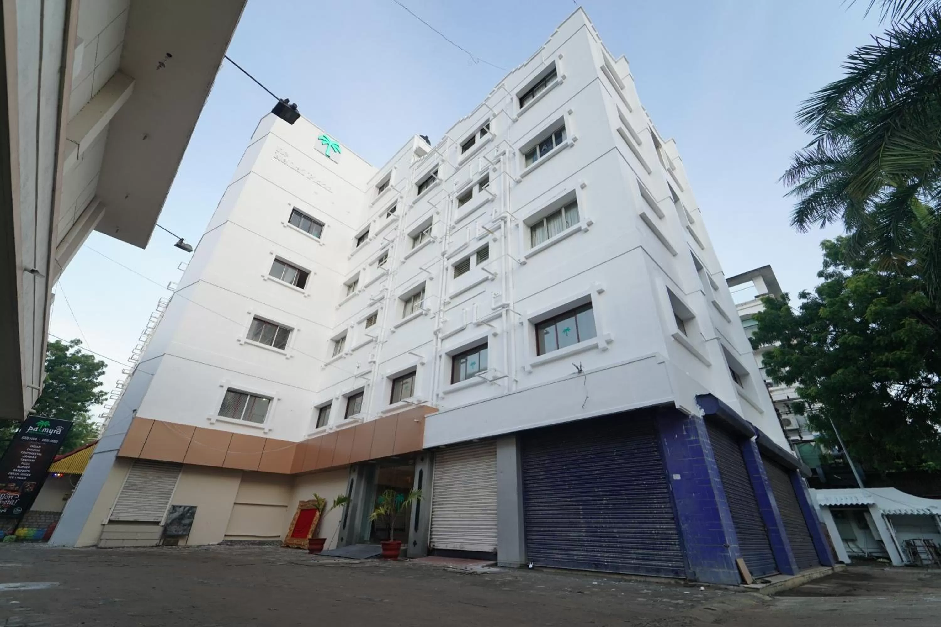 Property building in Hotel Palmyra Grand Inn