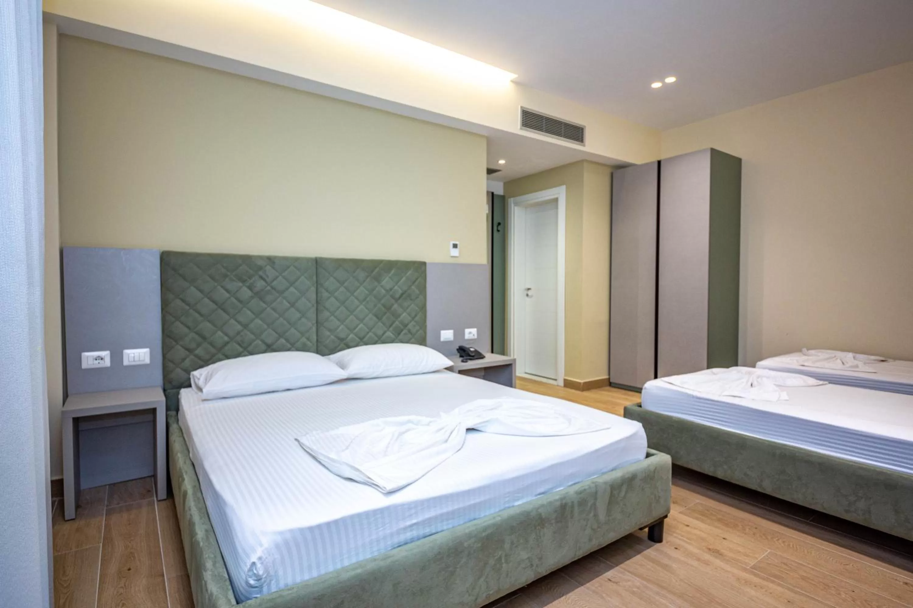 Quadruple Room with Balcony and Side Sea View in Hotel Bella Vista