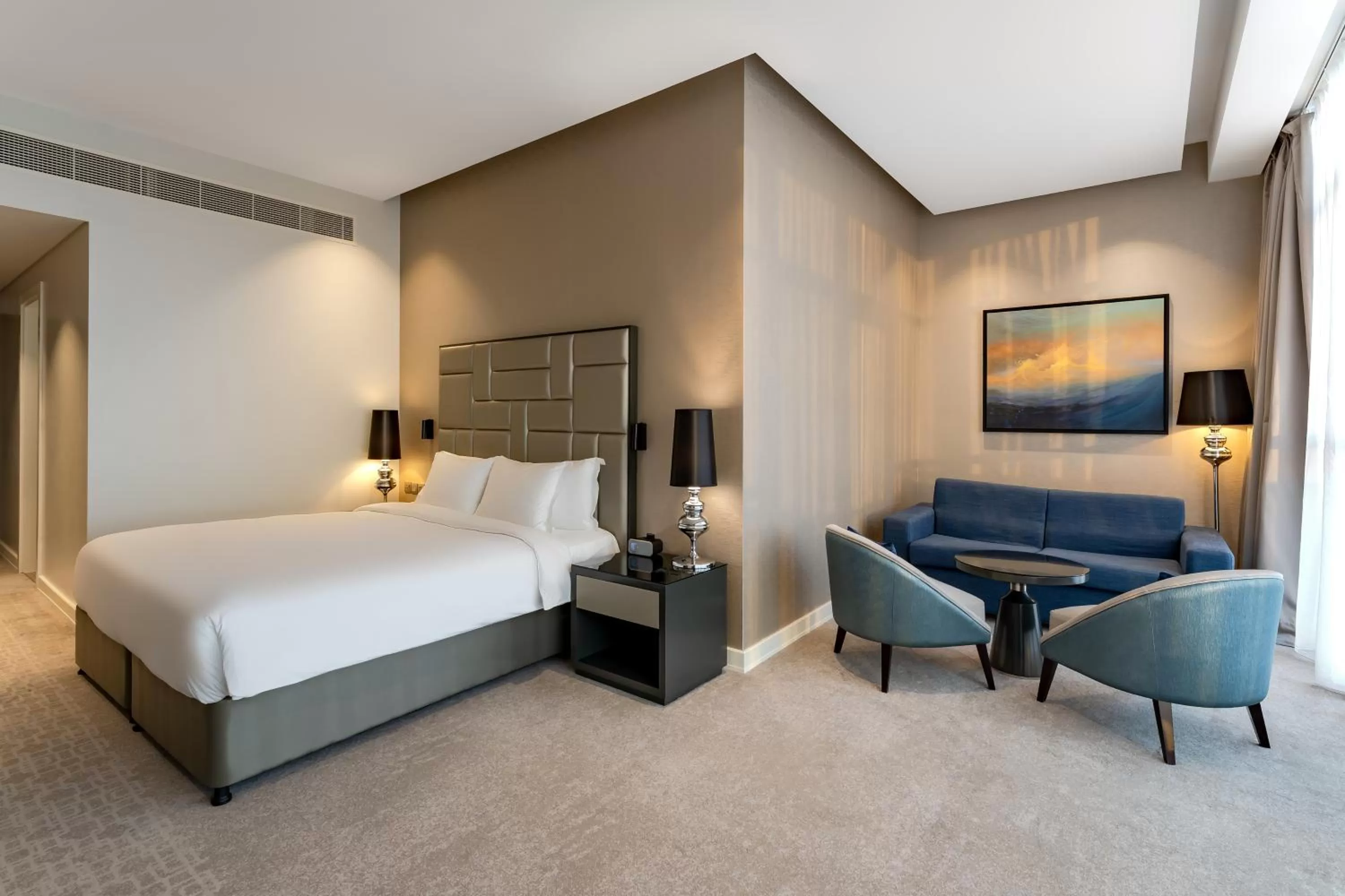 Seating area, Bed in Radisson Dubai Damac Hills