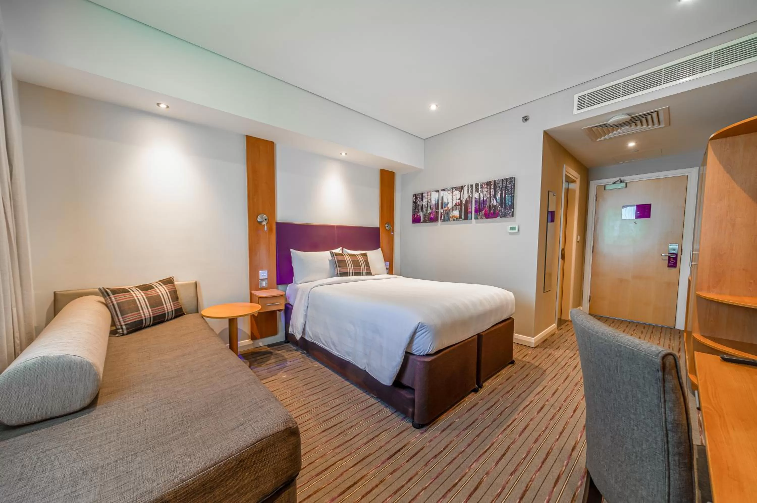 Seating area, Bed in Premier Inn Dubai Investments Park - An Emirates Group Company