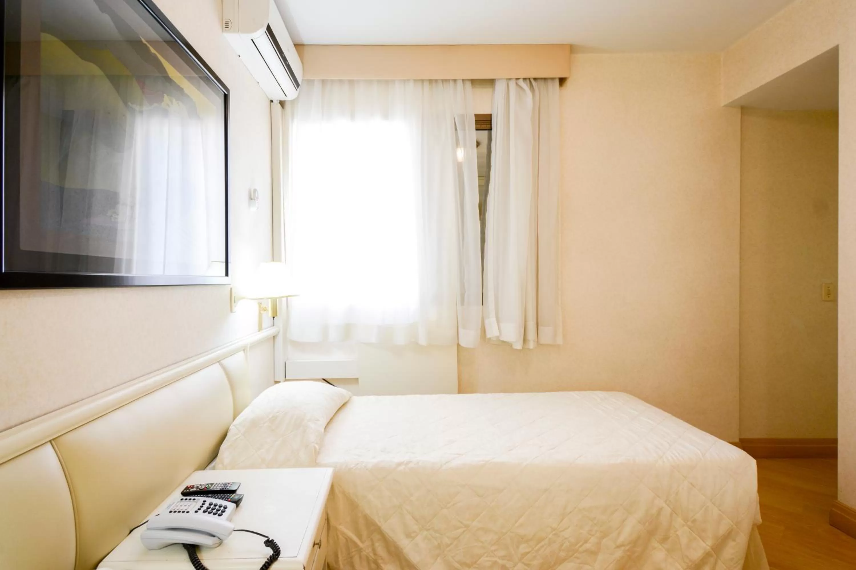 Bed in Wall Street Apartments by BnbHost