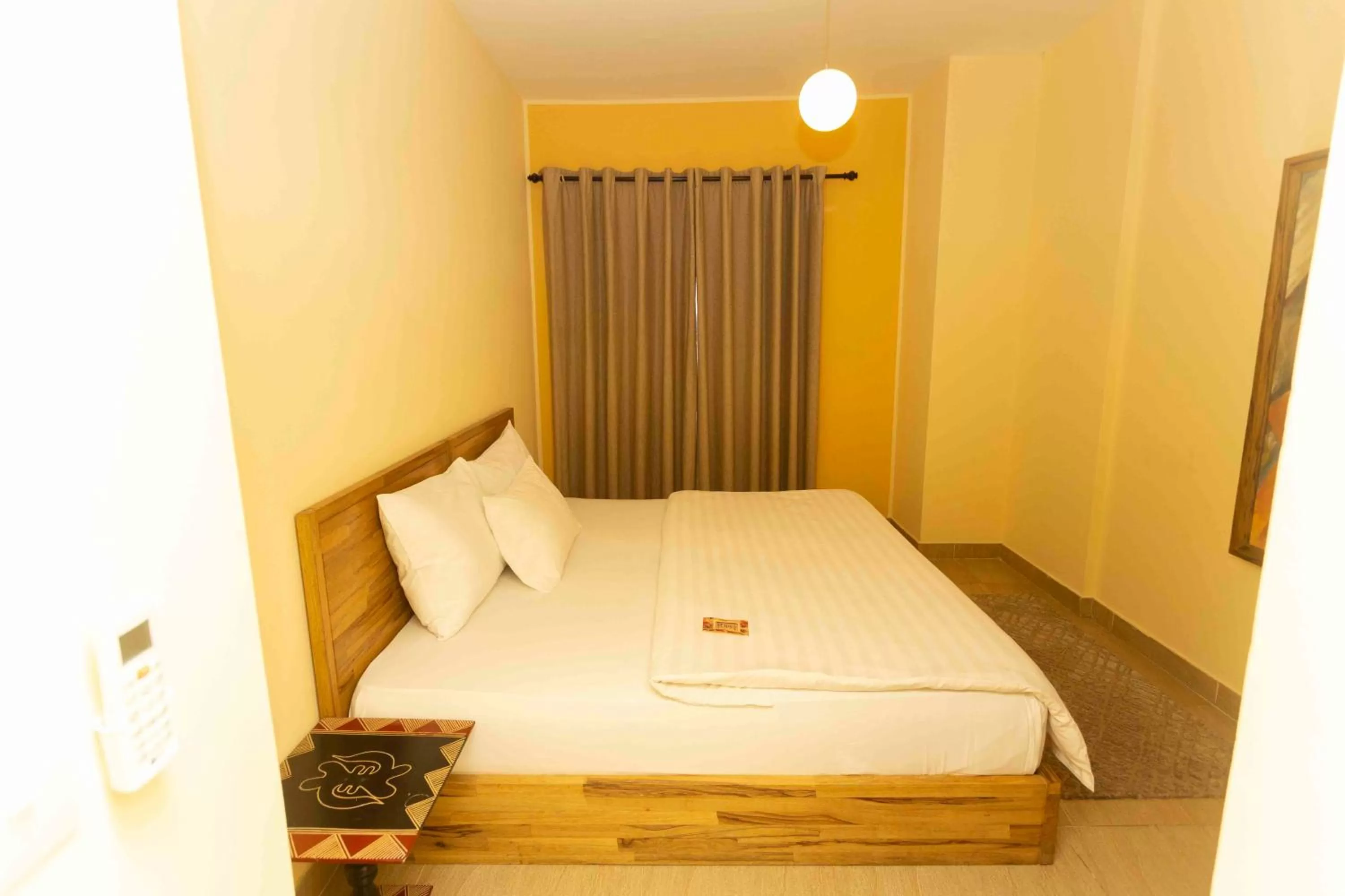 Bed in Roots Hotel Apartment