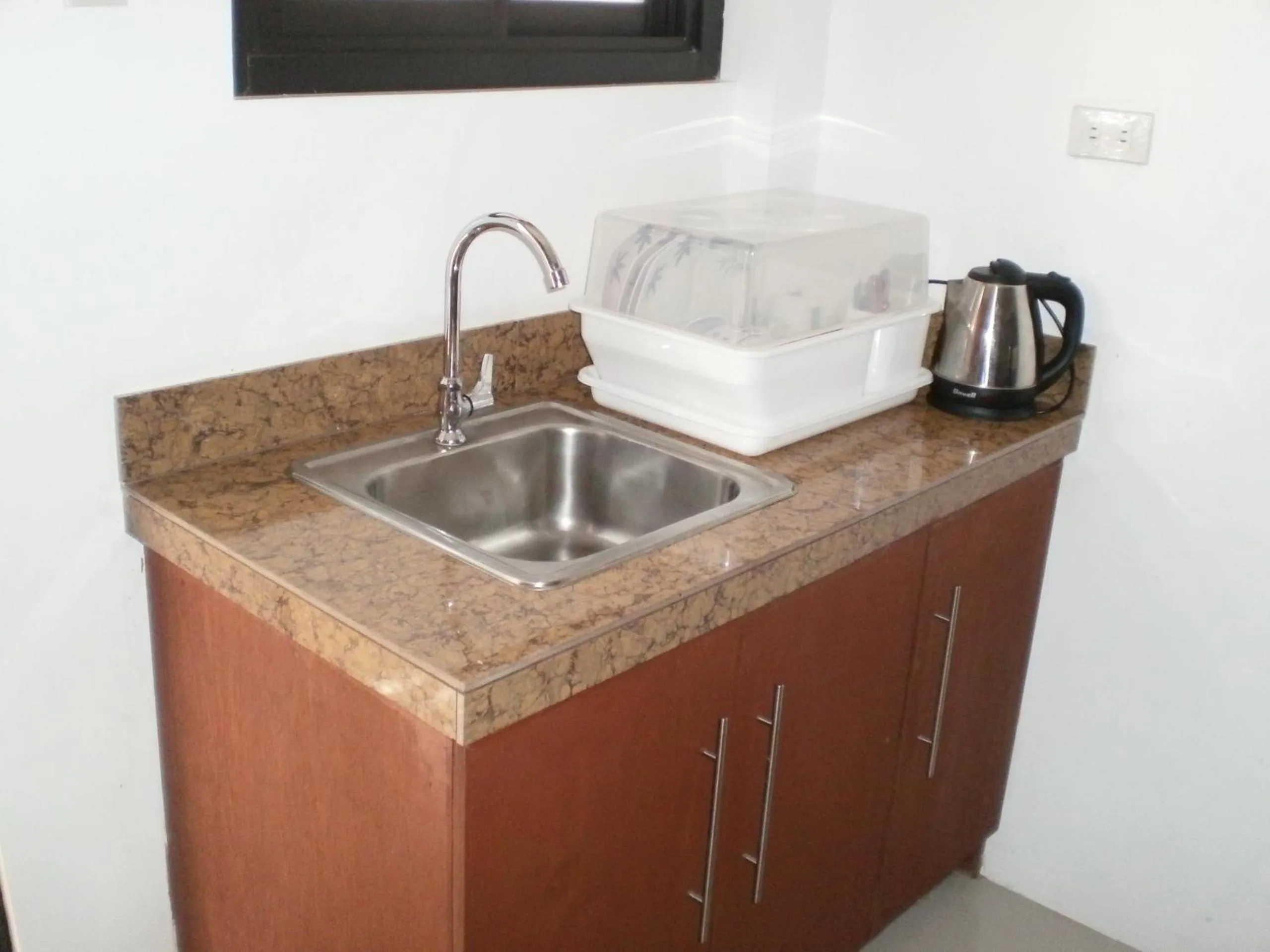 Kitchen or kitchenette in The Palines Apartment Hotel near Brittany Palazzo, Evia Mall Alabang
