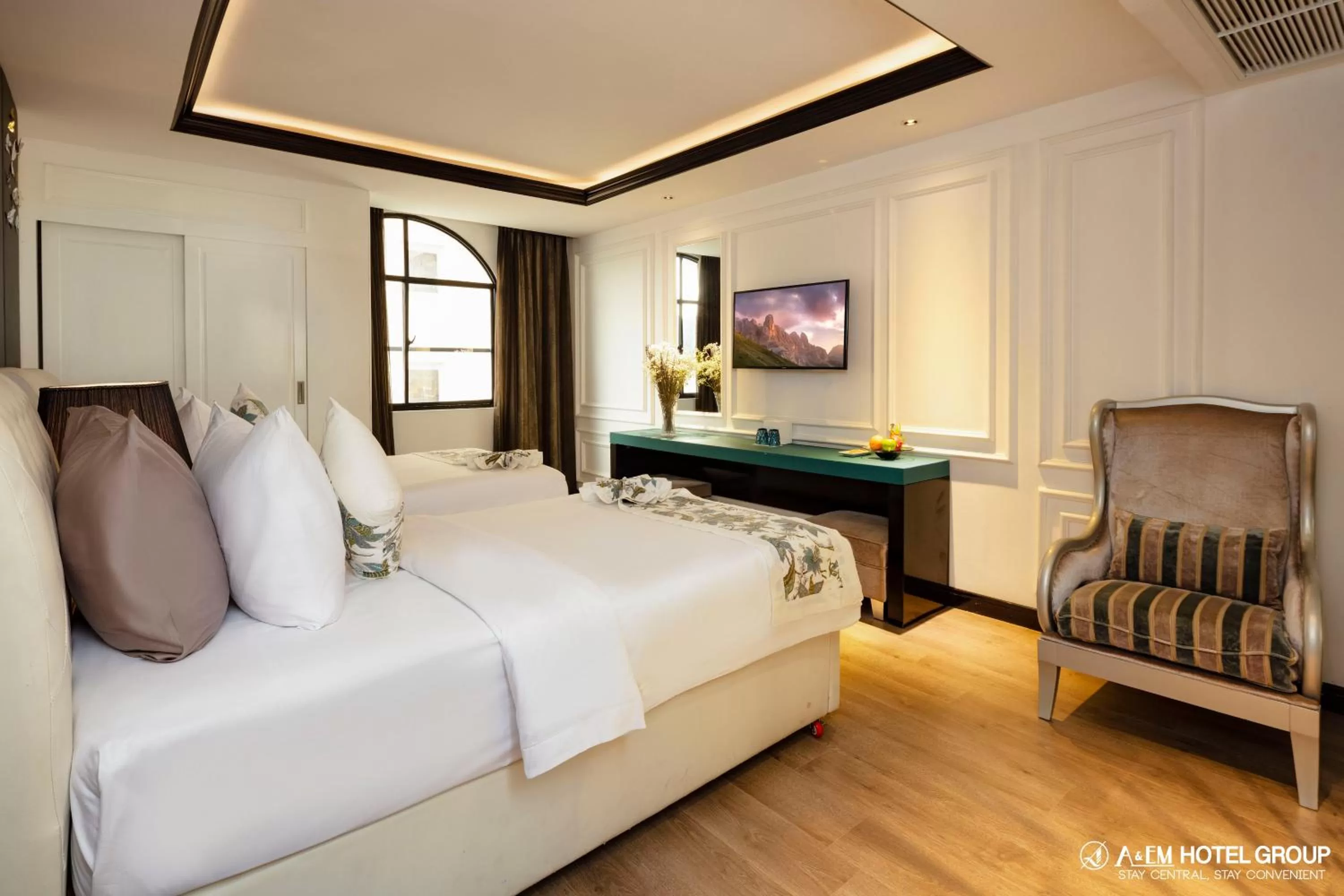 Bed in A&EM Saigon Hotel