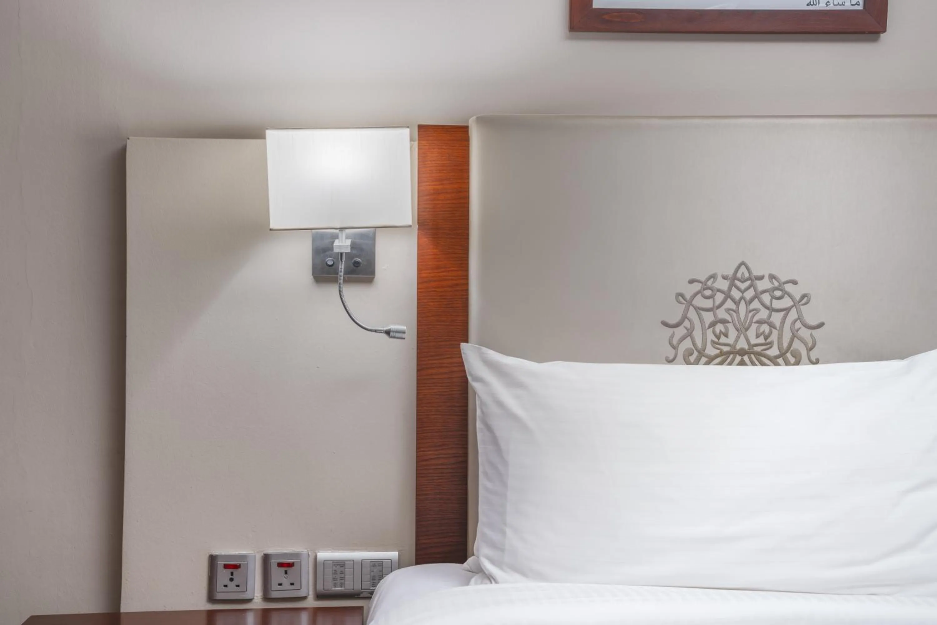 Bed in Millennium Al Aqeeq Hotel