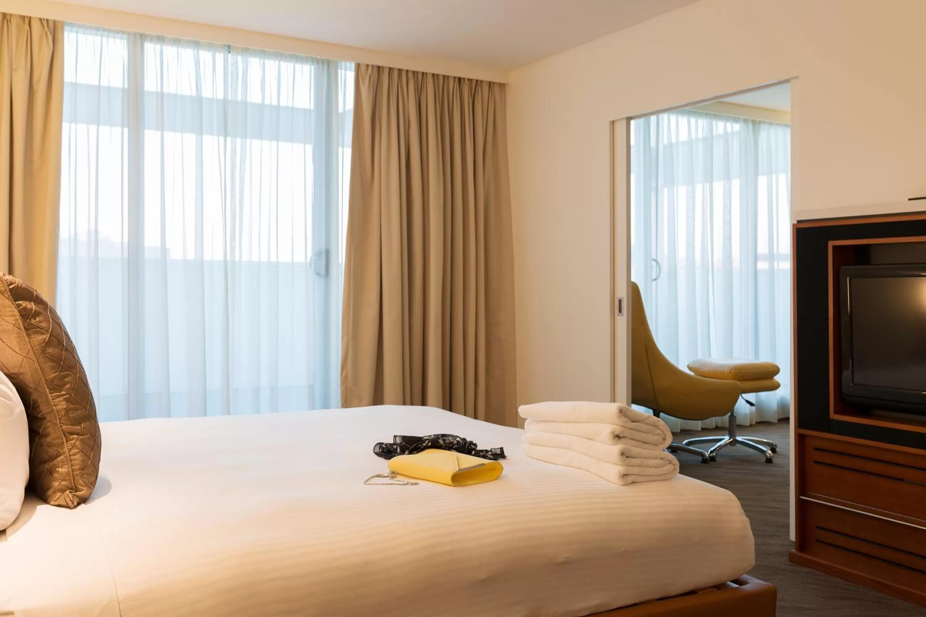 Seating area, Bed in Novotel Canberra
