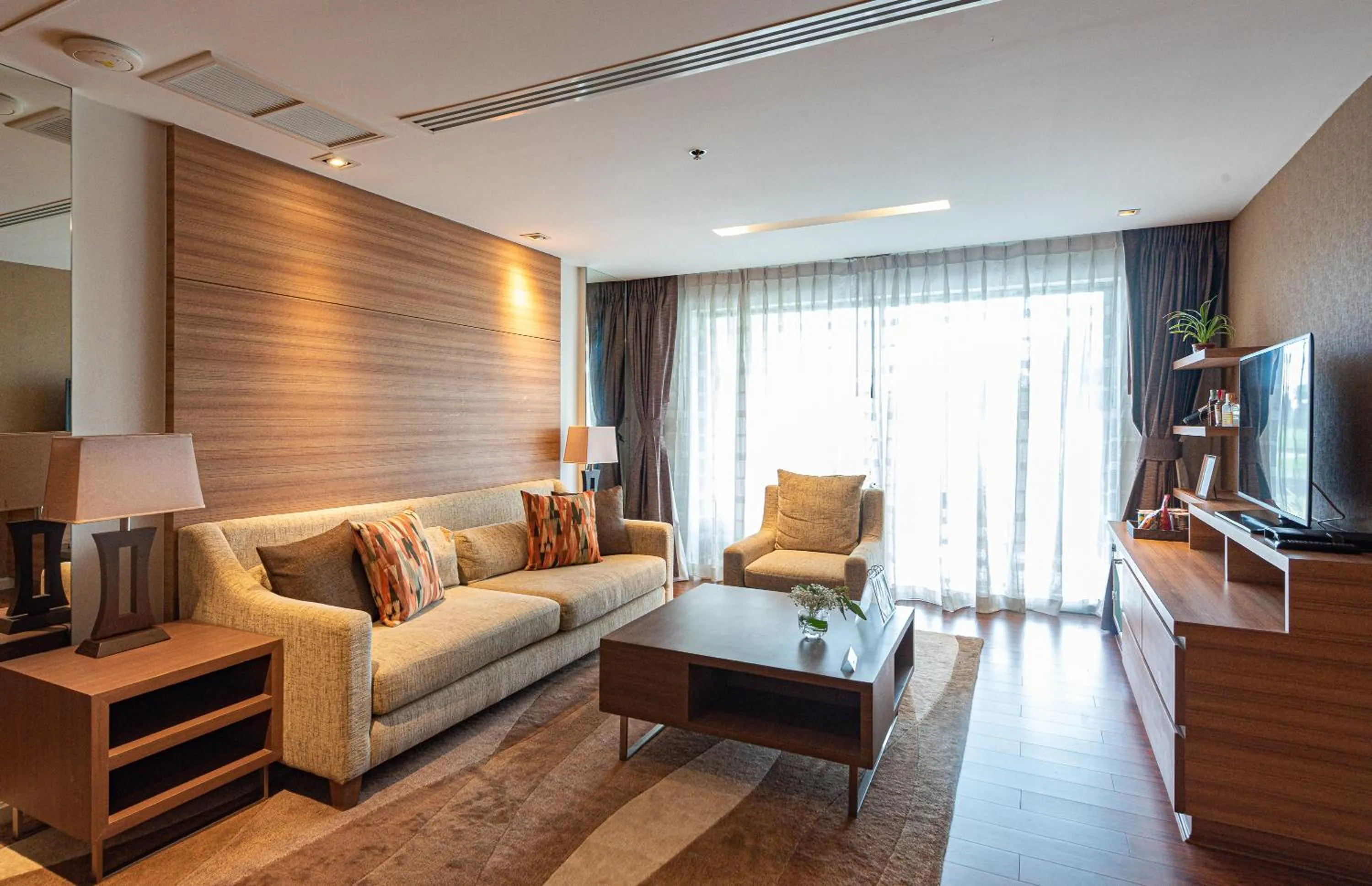 Living room in Summit Windmill Golf Suite Hotel at Suvarnabhumi