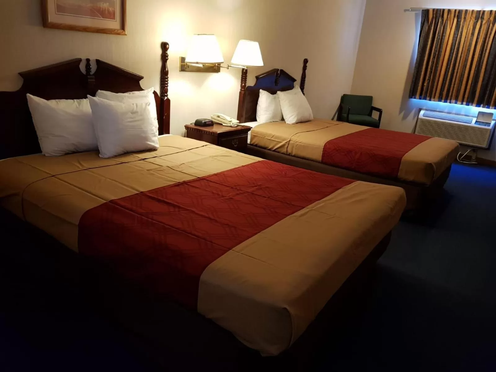 Bed in Denison Inn & Suites
