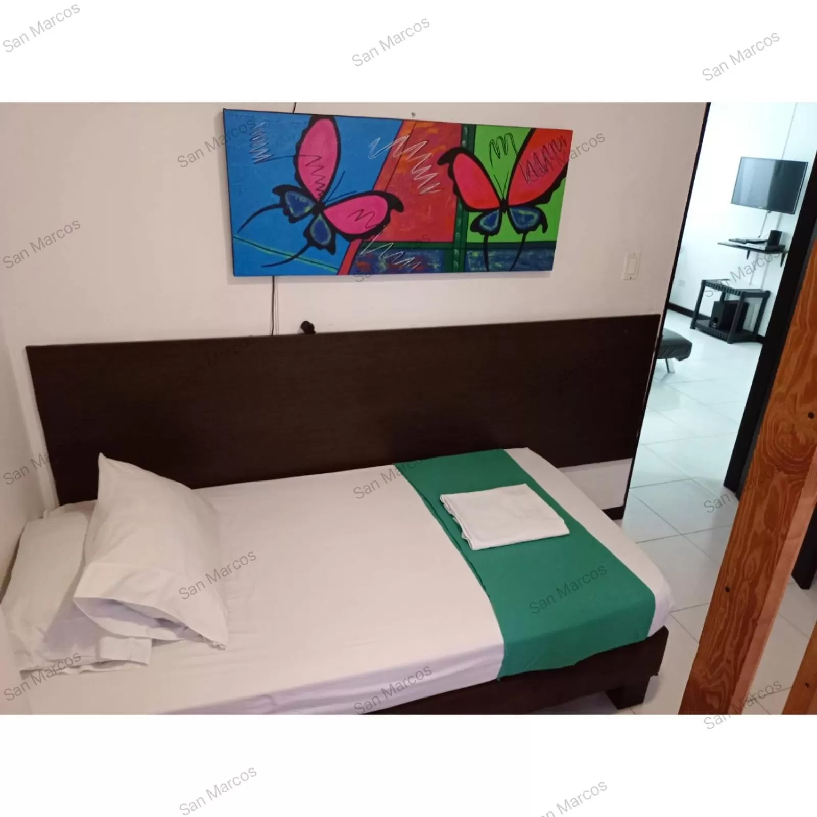 Bed in Apartasuites San Marcos