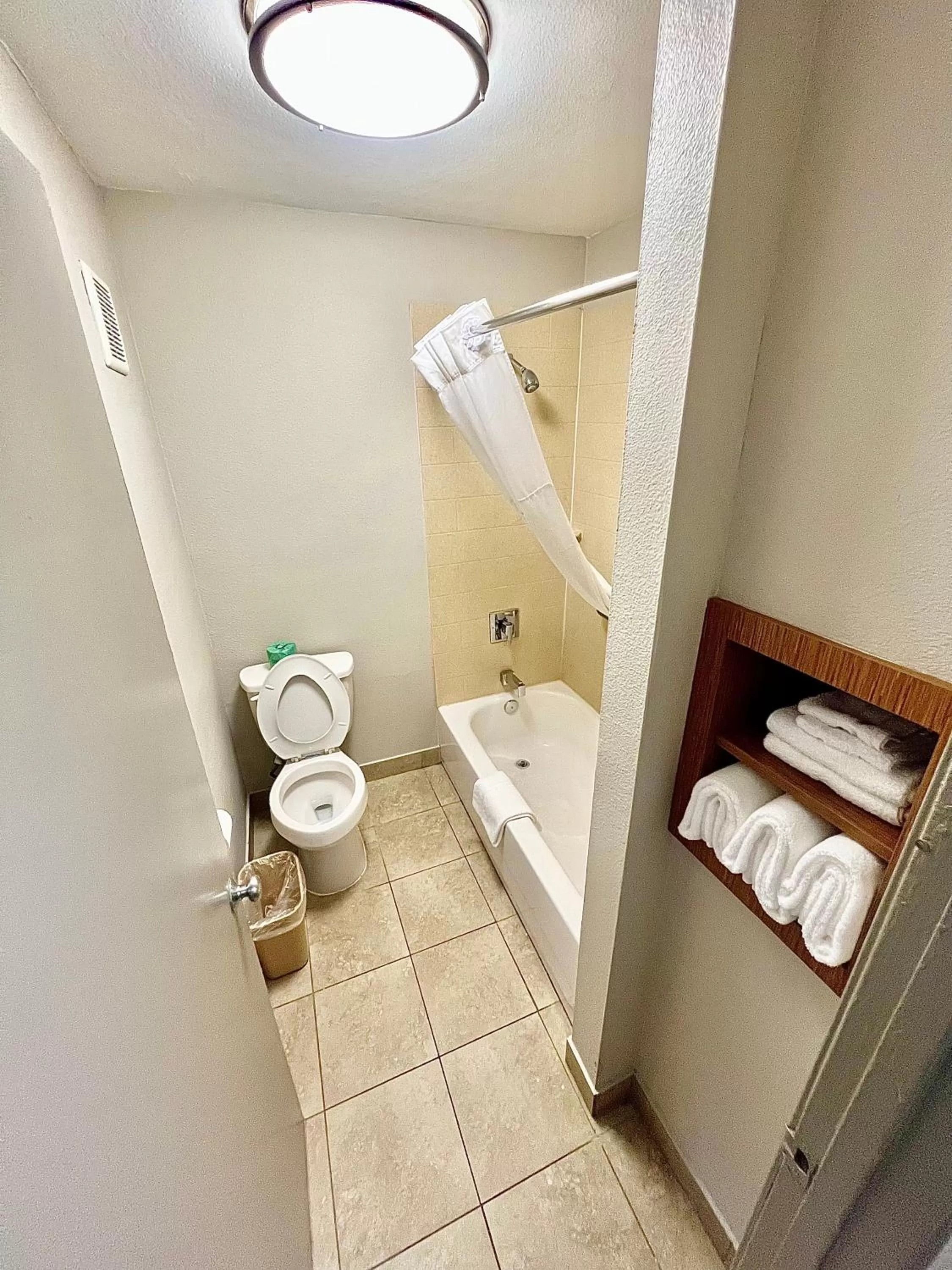 Toilet in Days Inn & Suites by Wyndham Arlington Near Six Flags