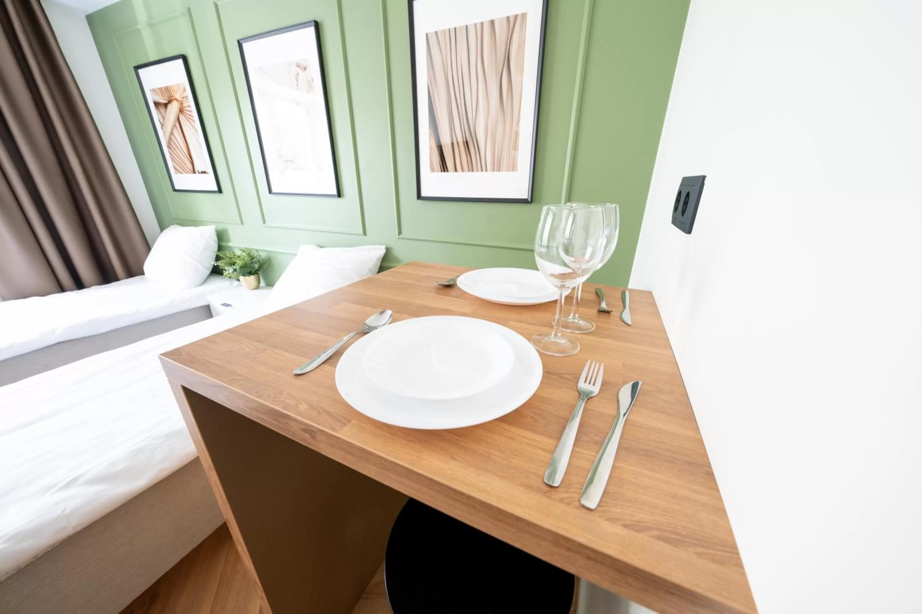 Dining area, Bed in Oasis Airport Studios by RevalHome