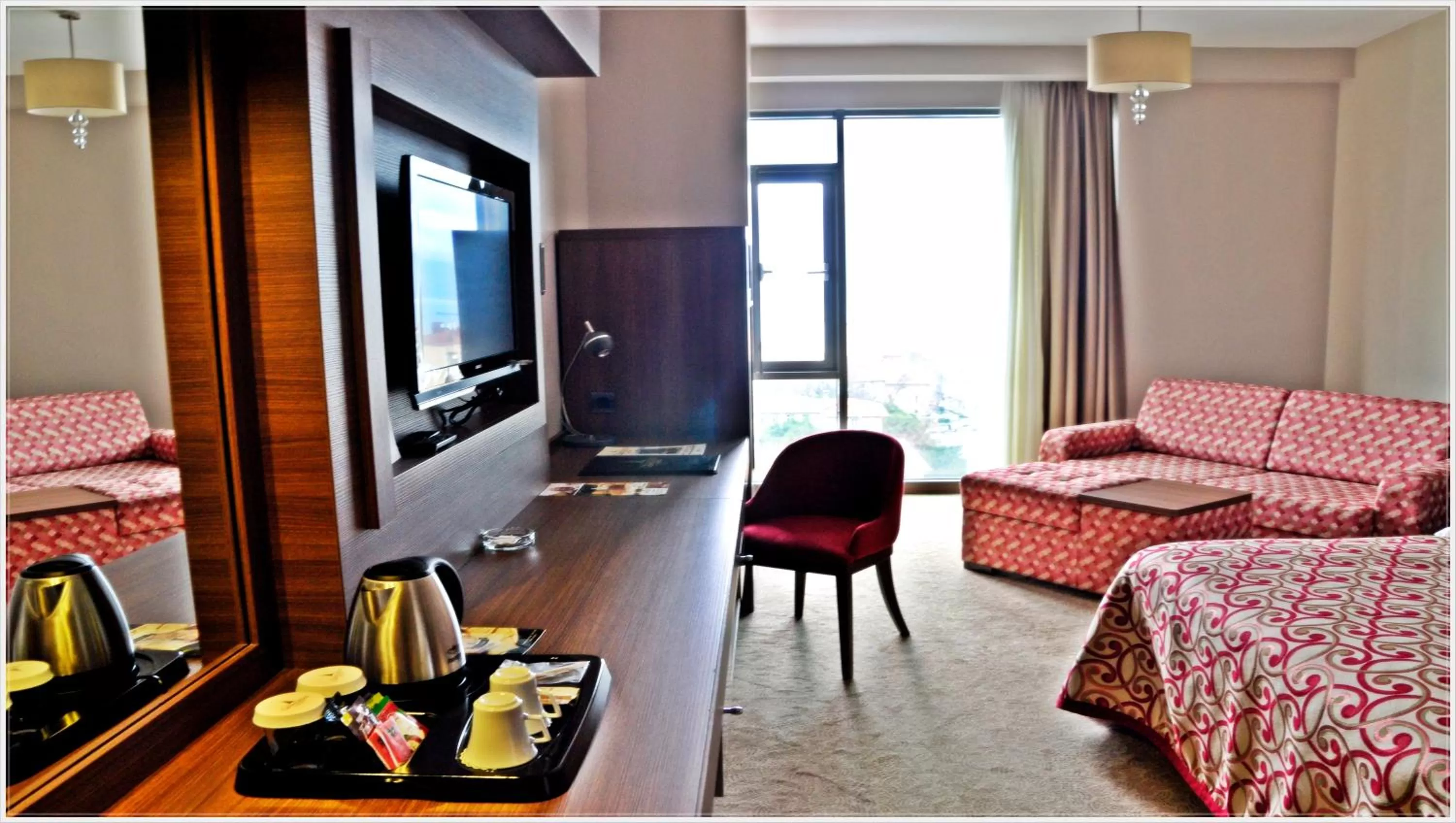 Communal lounge/ TV room, Bed in Grand Asya Hotel