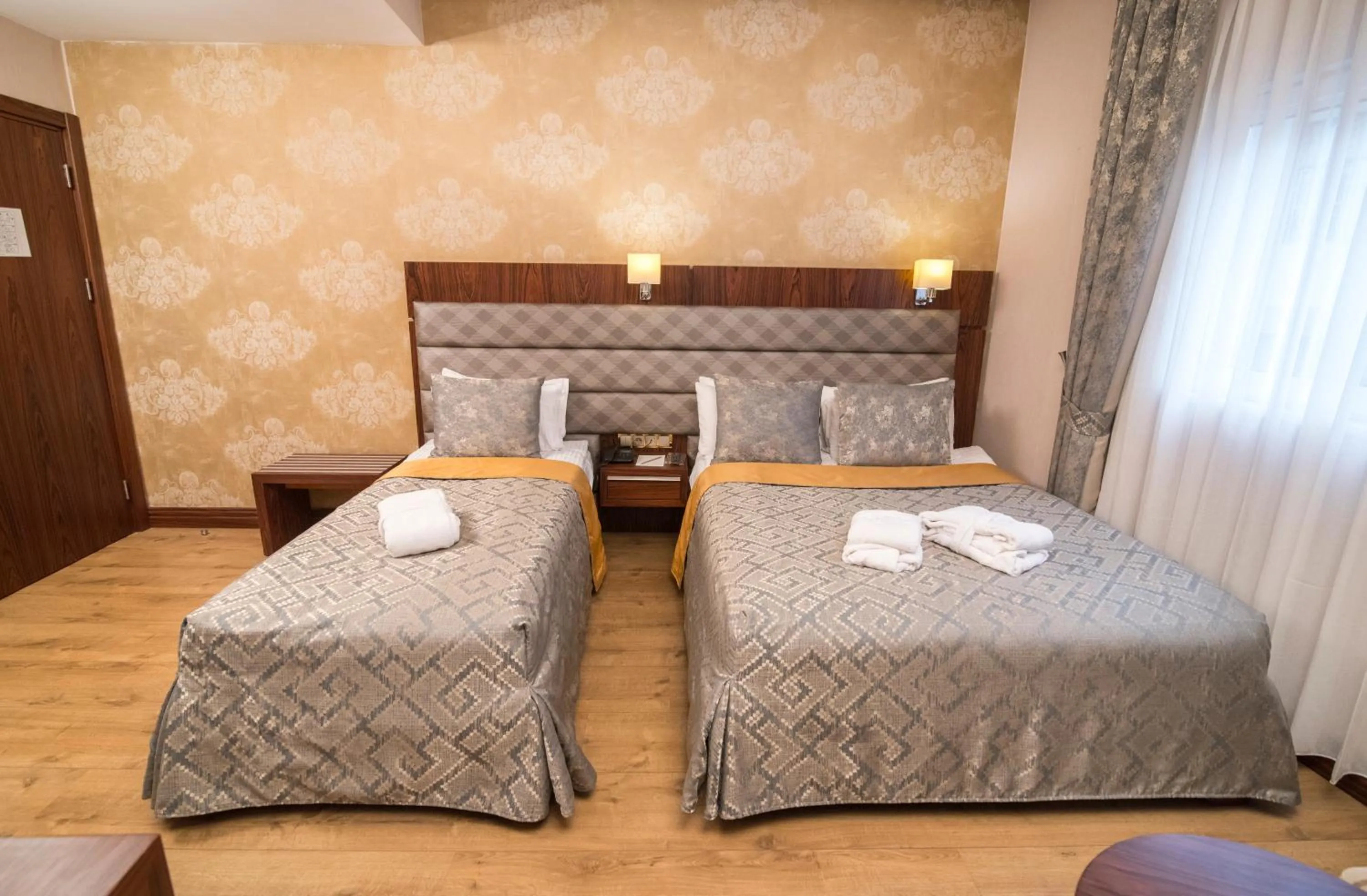 Bed in MidMar Deluxe Hotel