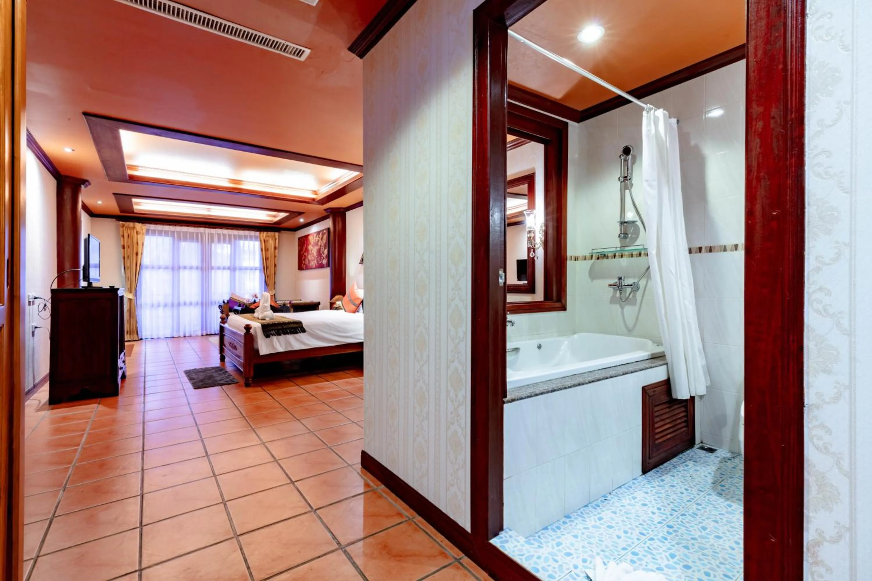 Photo of the whole room, Bed in Royal Phawadee Village Patong - 2 Minutes walk to the beach