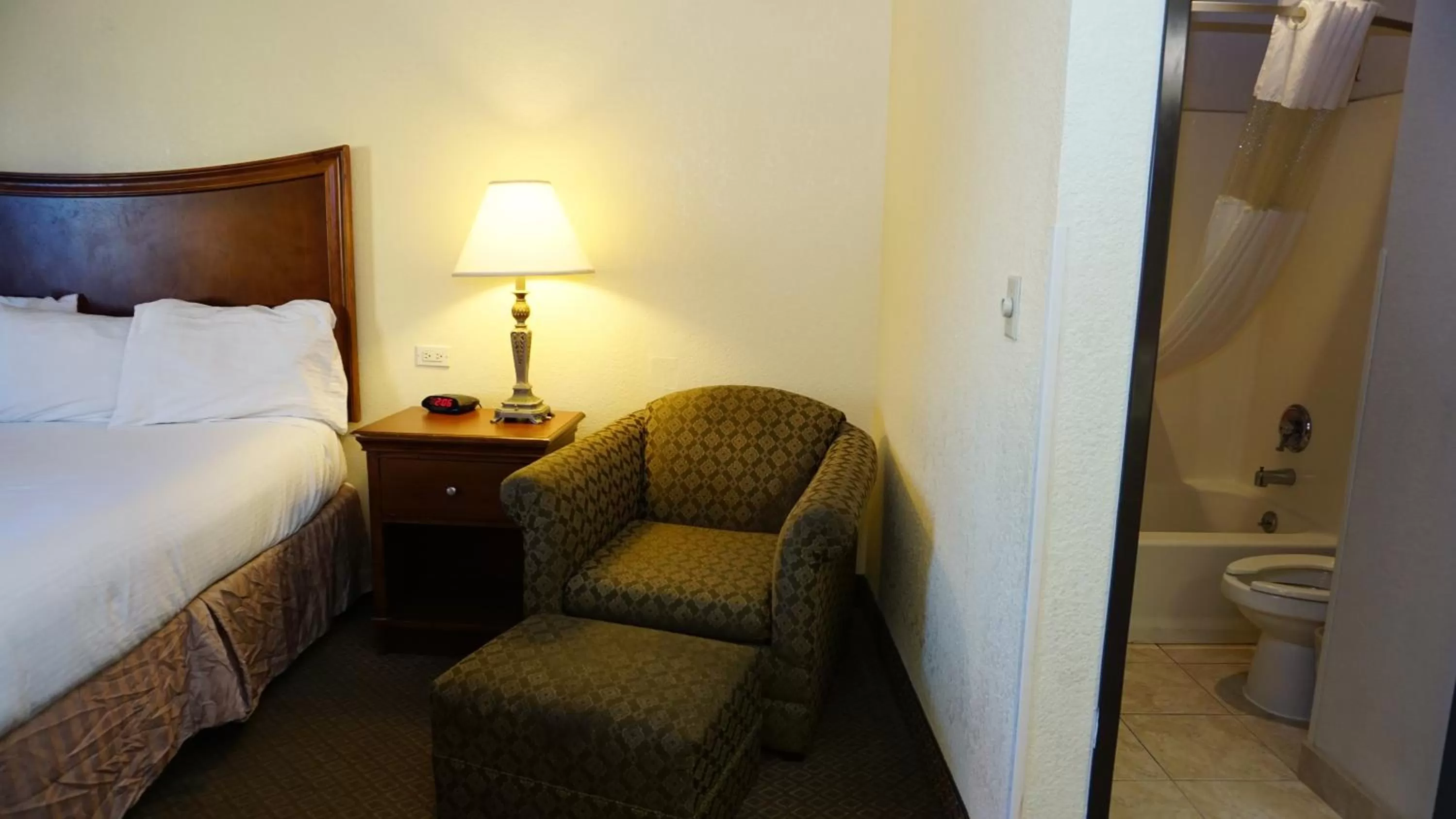 Seating area, Bed in Baymont by Wyndham Arlington At Six Flags Dr