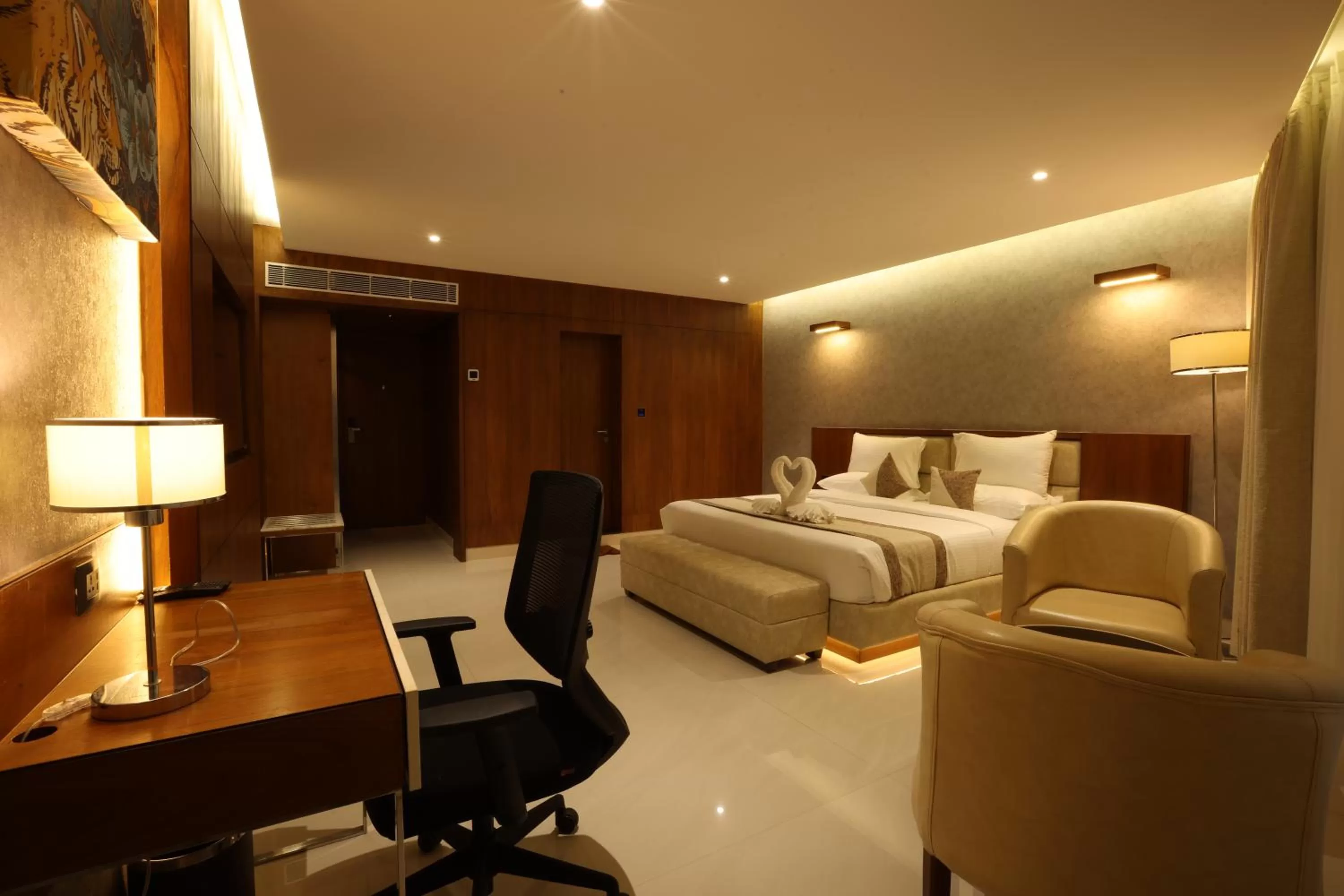 Seating area, Bed in Royal Plaza Suites by RAK Rooms, Mangaluru