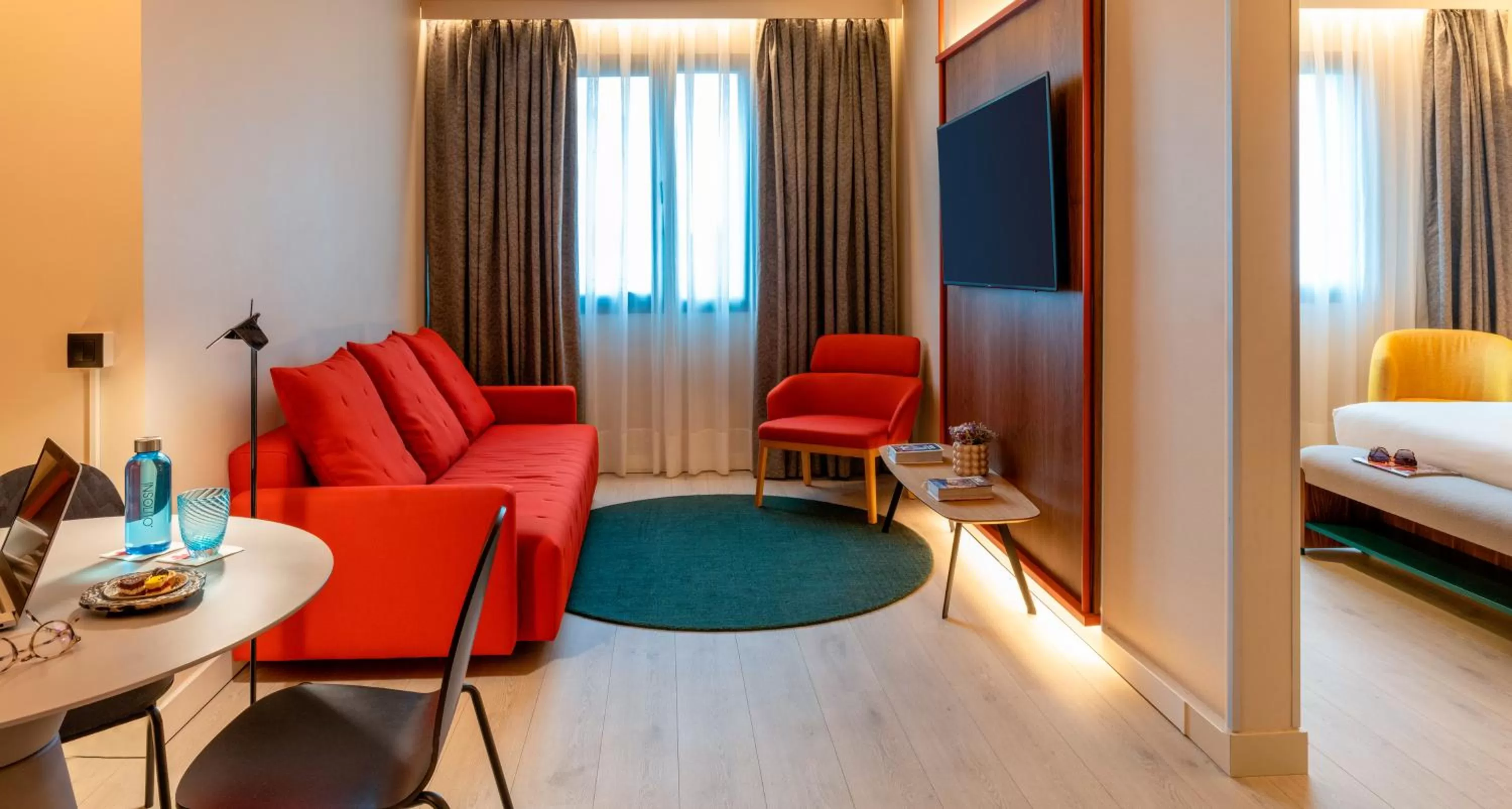 Living room, Bed in Novotel Madrid City Las Ventas