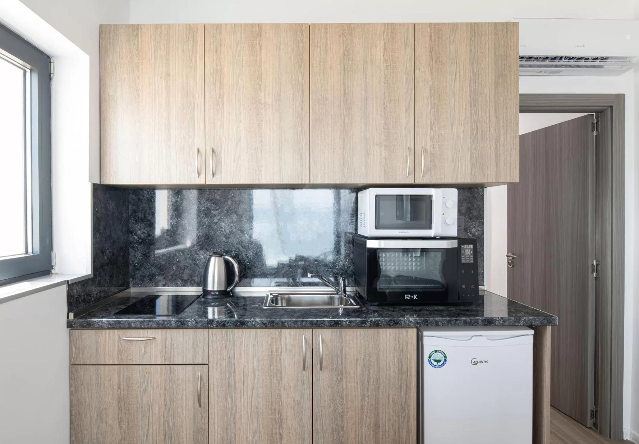 Kitchen or kitchenette in Grand Dodo's Triada Seaview Studios
