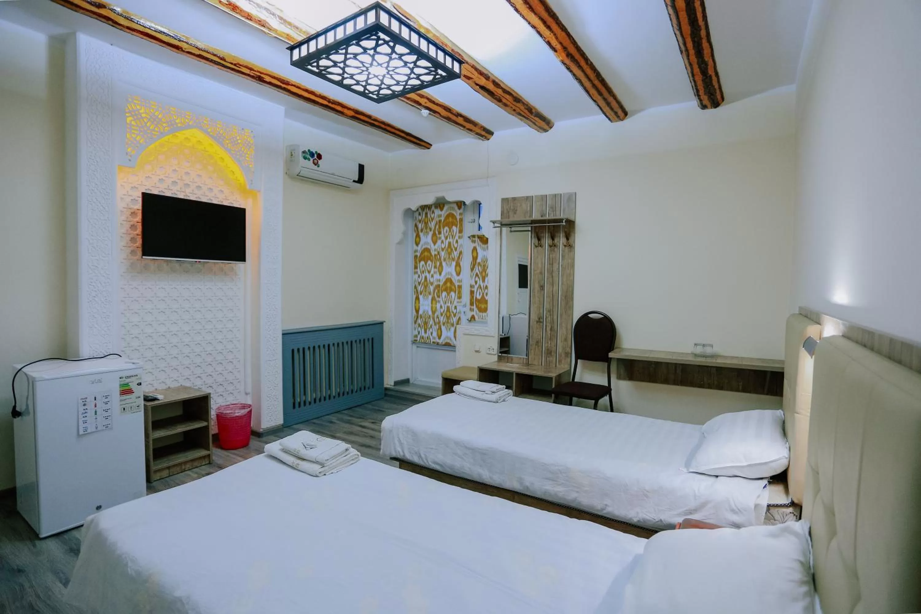 Communal lounge/ TV room, Bed in Bukhara house hotel