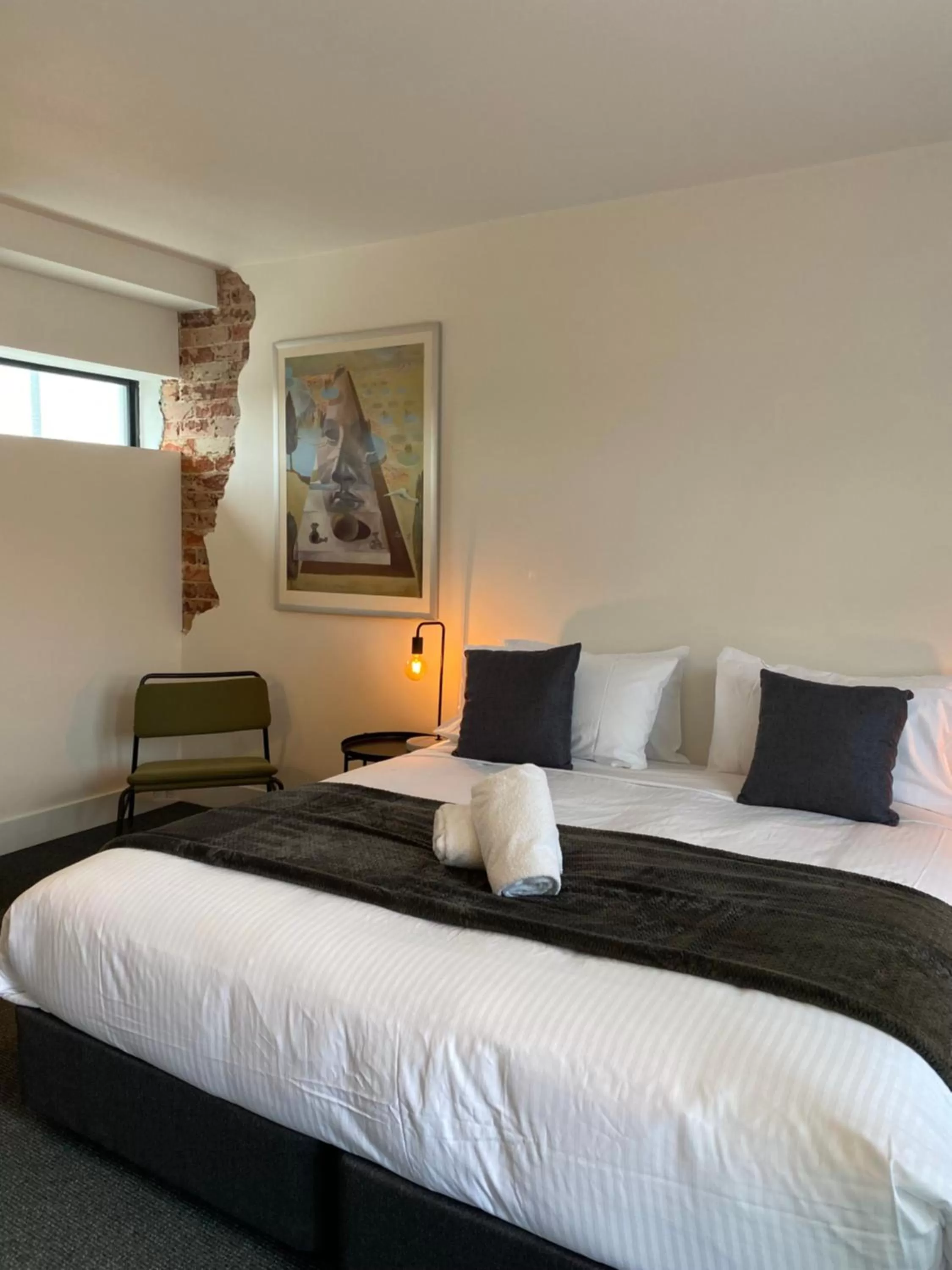 Bed in The Astor Hotel Motel