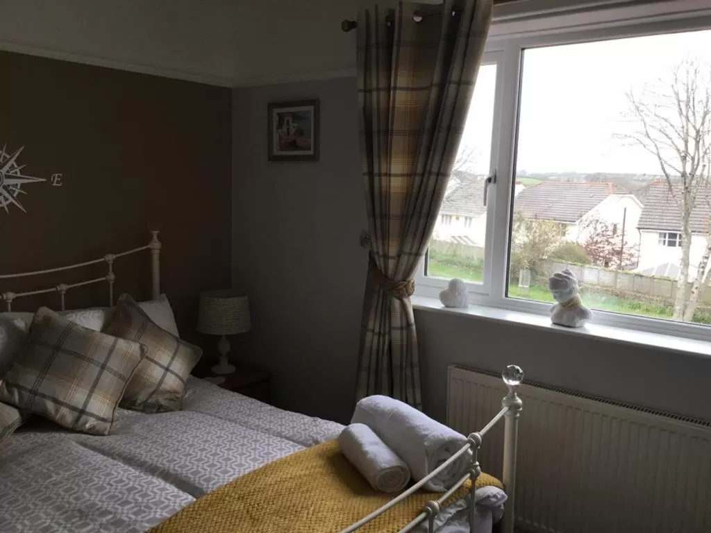 Bed in TRETHEWEY GUEST HOUSE