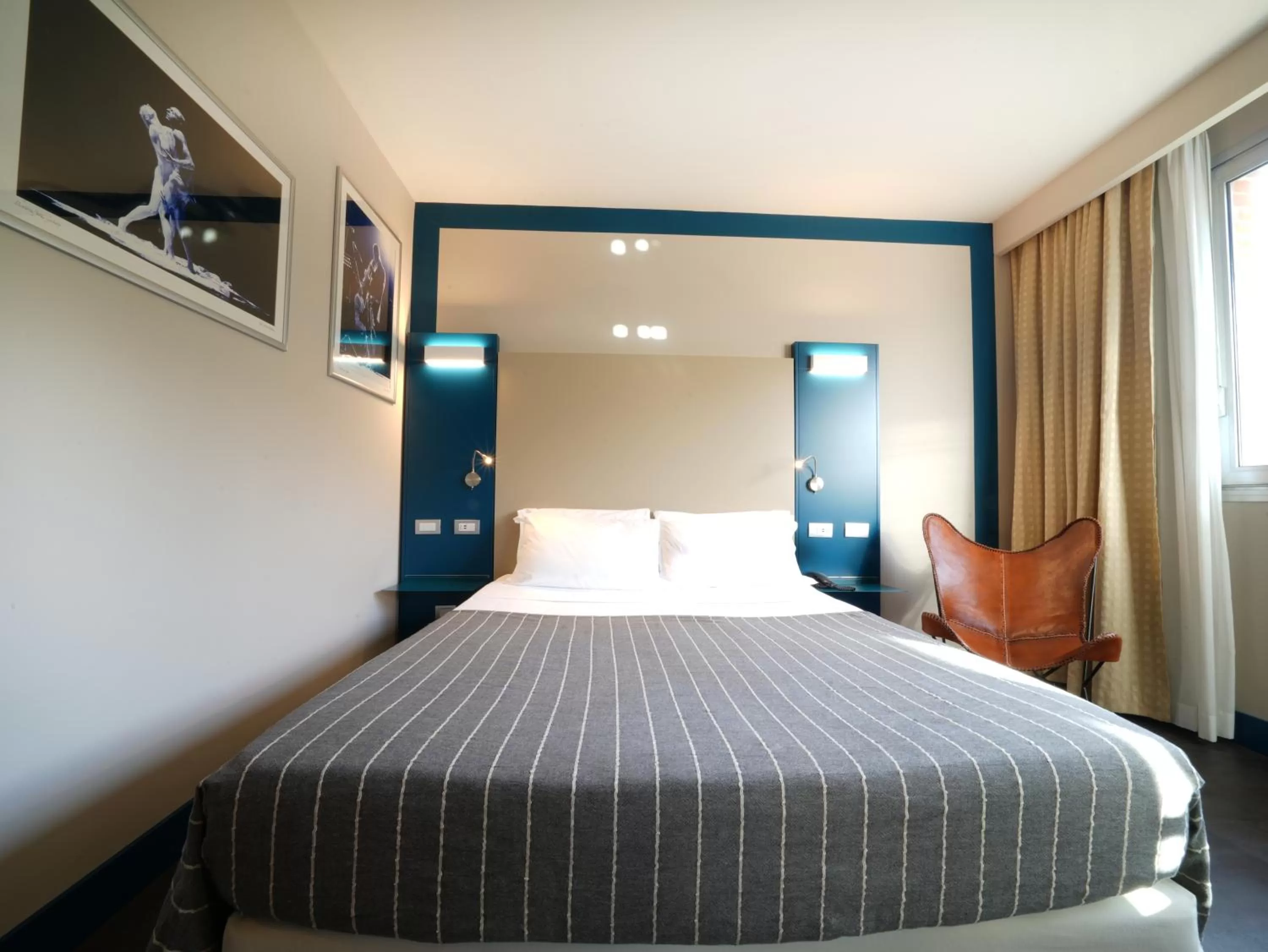 Bed in La Meridiana Bleisure Hotel