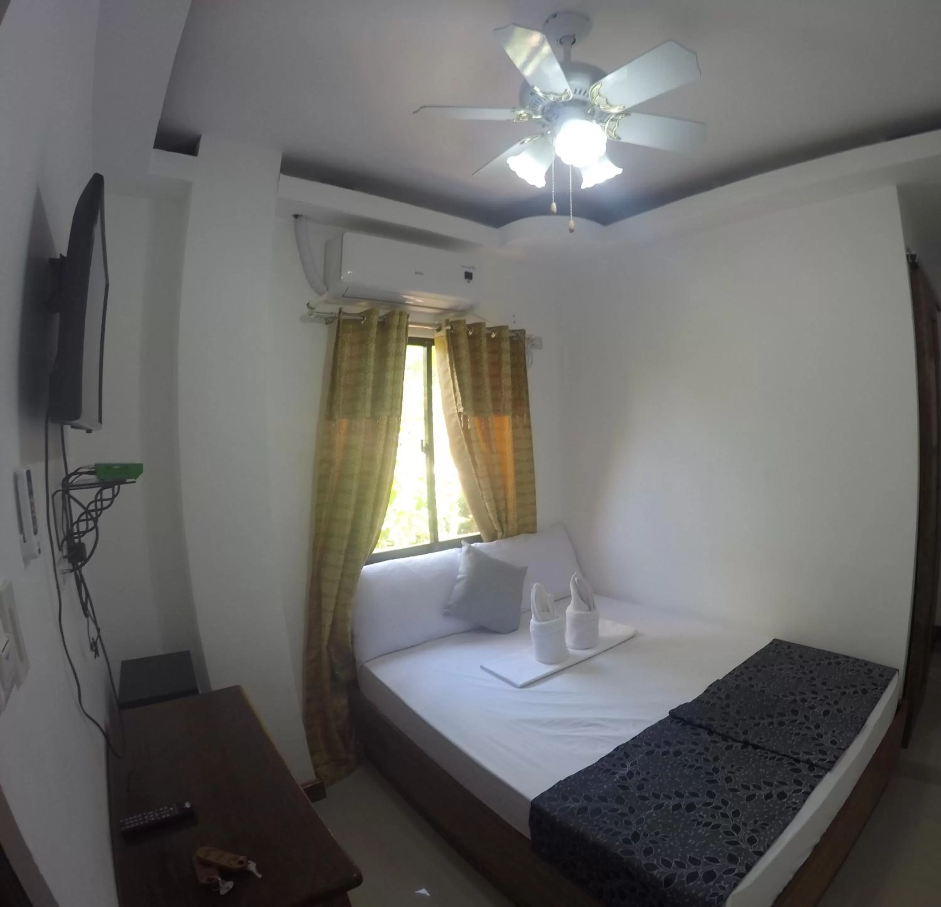 Bed in El Nido Royal Palm Inn