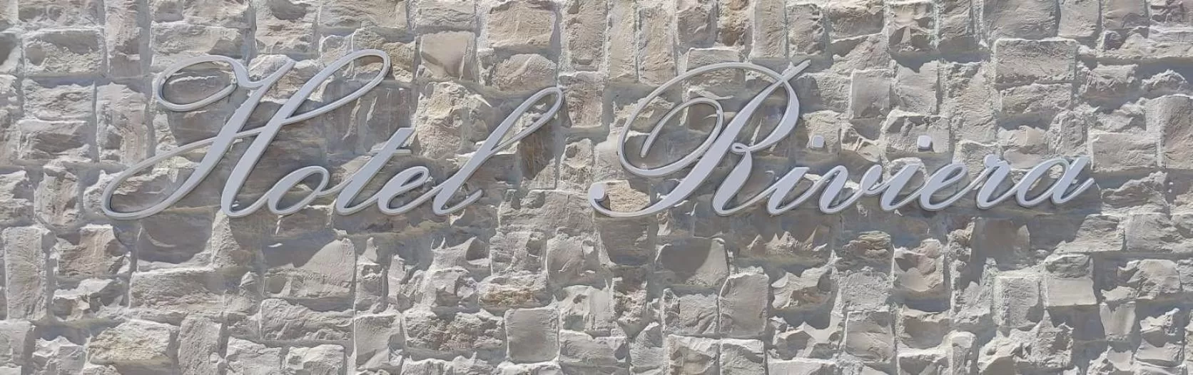 Property logo or sign in Hotel Riviera