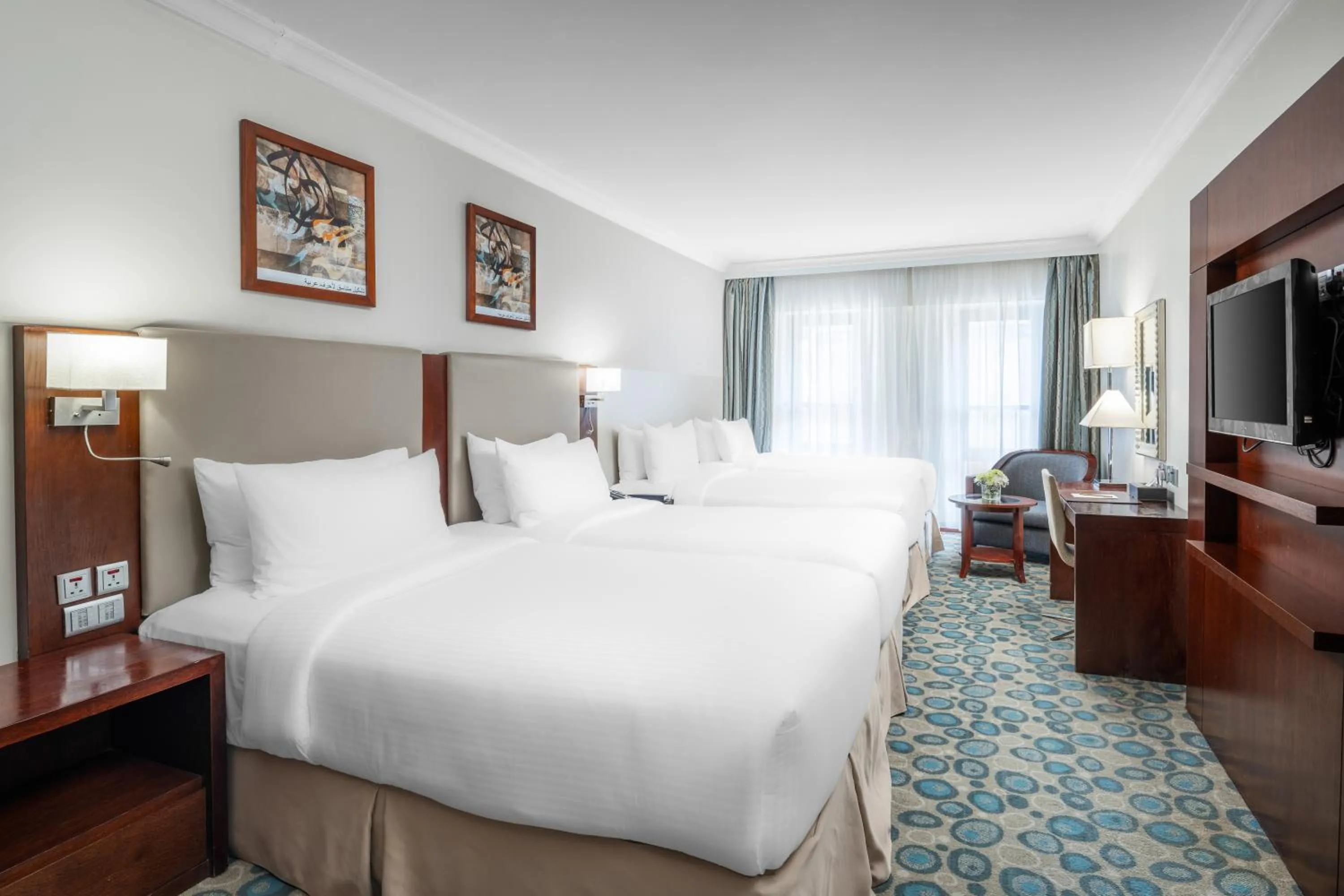 Bed in Millennium Al Aqeeq Hotel