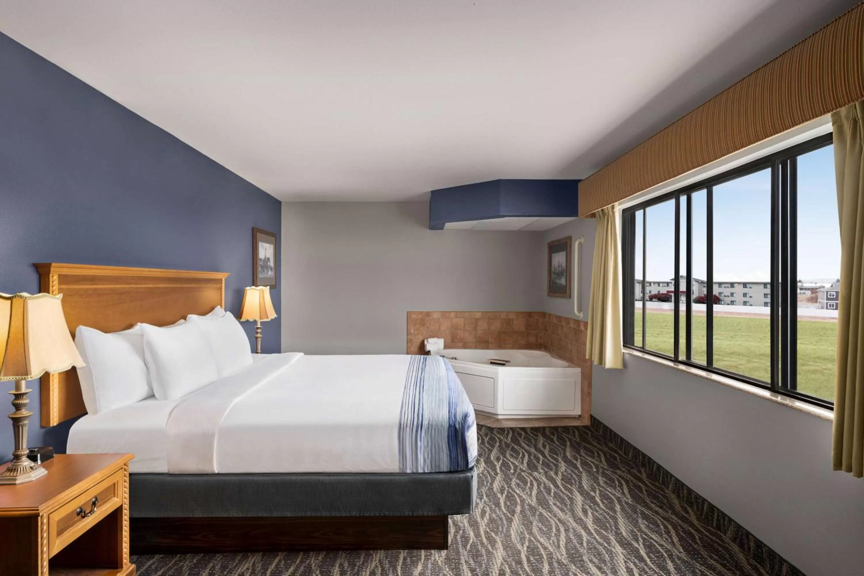 Bed in AmericInn by Wyndham Laramie Near University of Wyoming