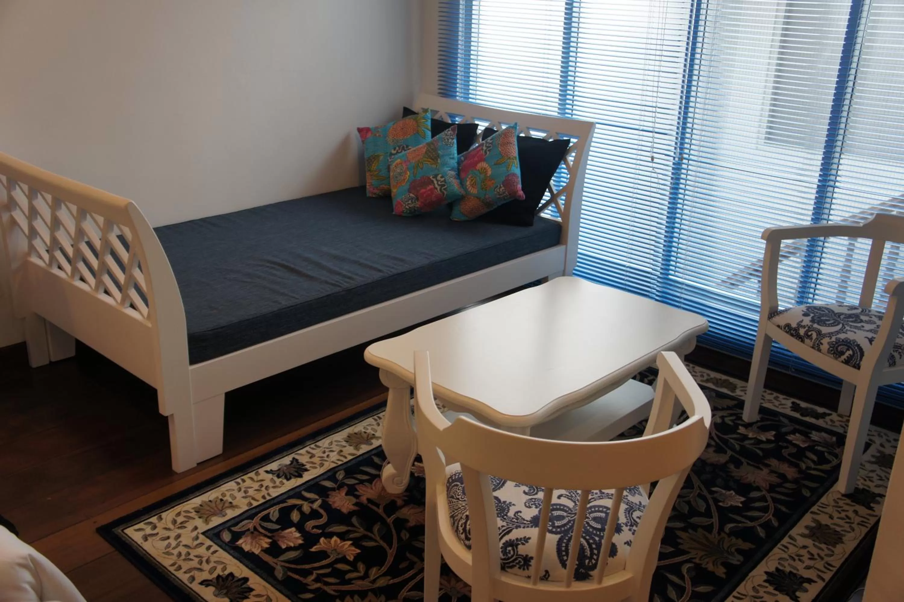 Seating area, Bed in Heeren Palm Suites